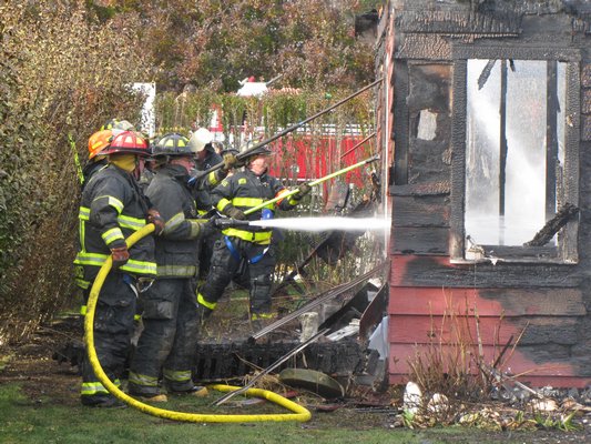 Fire raged through a cottage on Townline Road in Sagaponack on Friday afternoon. Firefighters from Bridgehampton and East Hampton Fire Departments responded and doused the flames but the structure was destroyed. Michael Wright