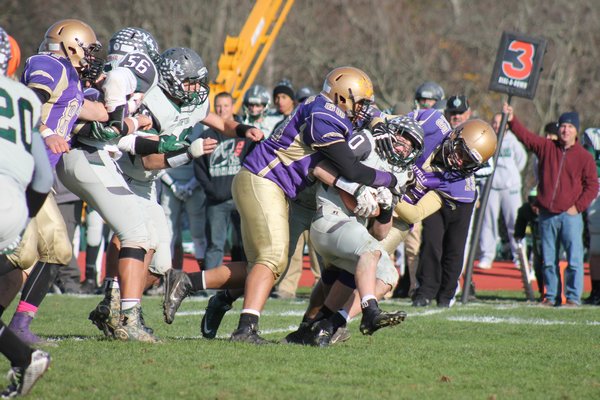  and Max O'Henry attempt to bring down Sayville's Ashton Bradley. KERRY MONACO
