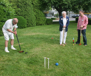 Jonathan Holding plays a round of croquet at the Westhampton Mallet Club's 50th Anniversary Celebration Saturday on the Village Green. JESSICA DINAPOLI