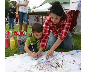Zachary Bahamondes working on a Pollock-esque T-shirt with help from Trish Franey.
