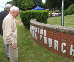 Karl Whorlitz examined the crumbling lettering on the church's sign.