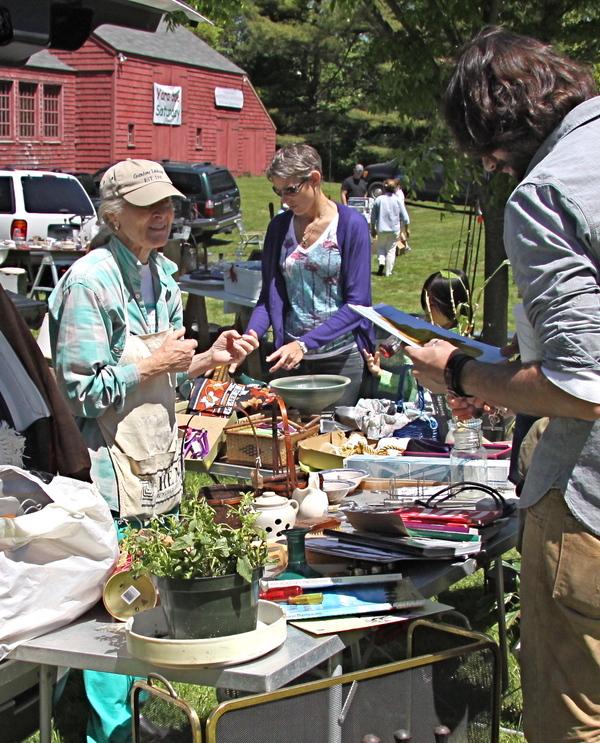 Carole Ray displays her wares for customers at the Amagansett Historical Society's community yard sale at Miss Amelia's Cottage on Saturday.