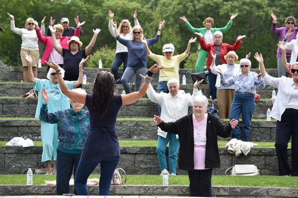 Gina Caccavalla leads seniors in a seated yoga session at Good Ground Park in Hampton Bays. COURTESY HEATHER SMITH