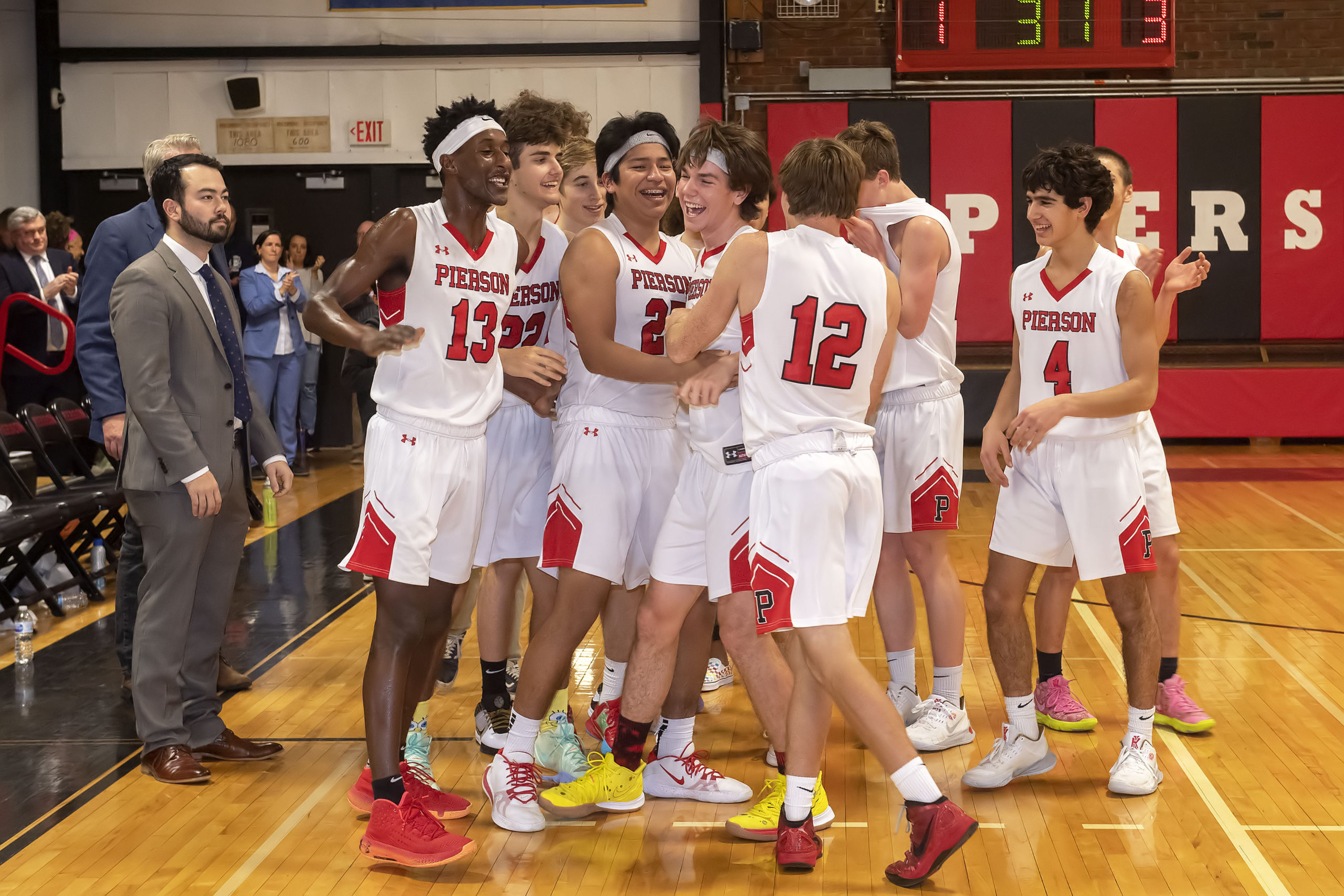 Pierson's Henry Brooks is mobbed by his teammates after making his 1,000th career point.