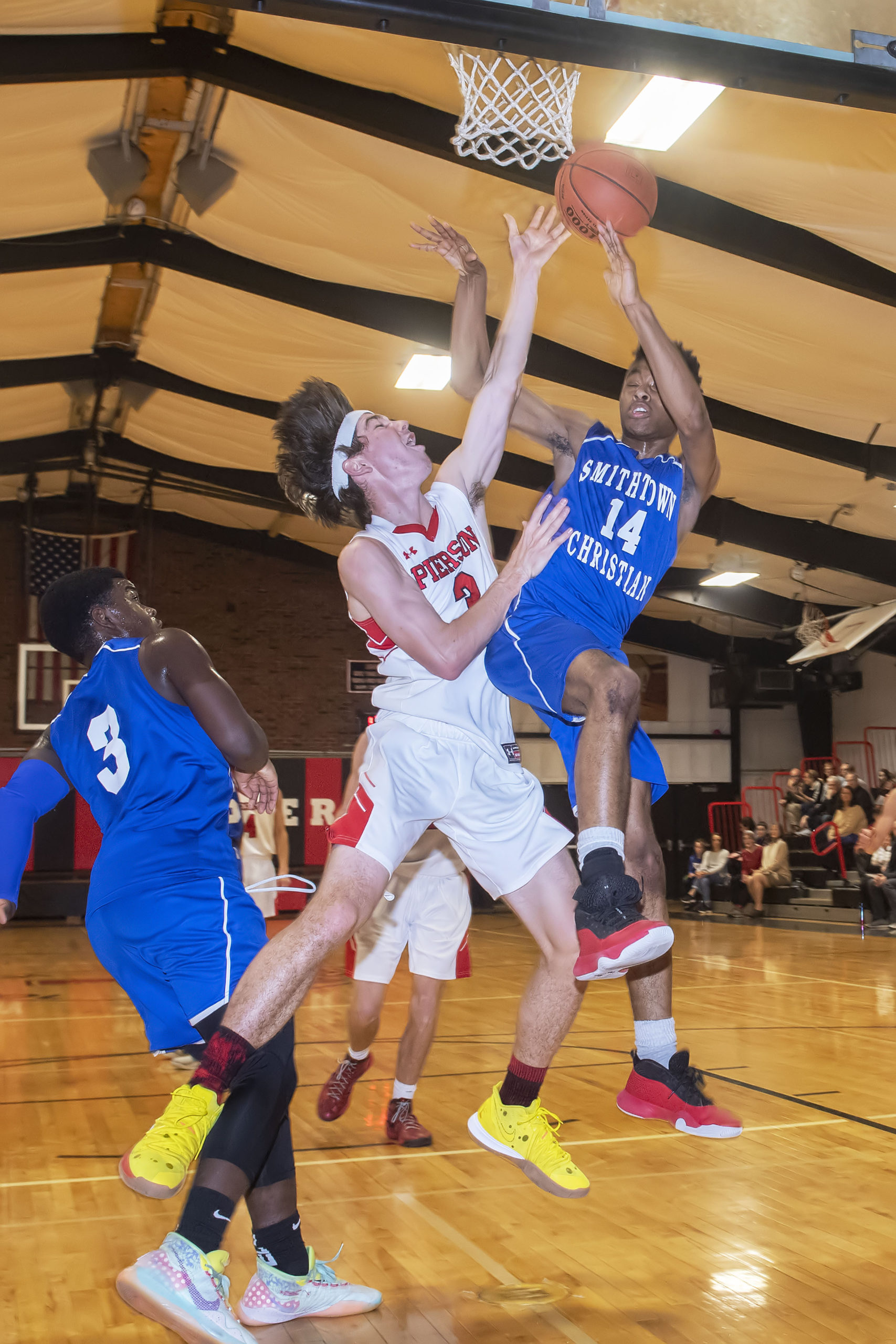 Pierson's Henry Brooks goes up with a Smithtown Christian player for the ball.