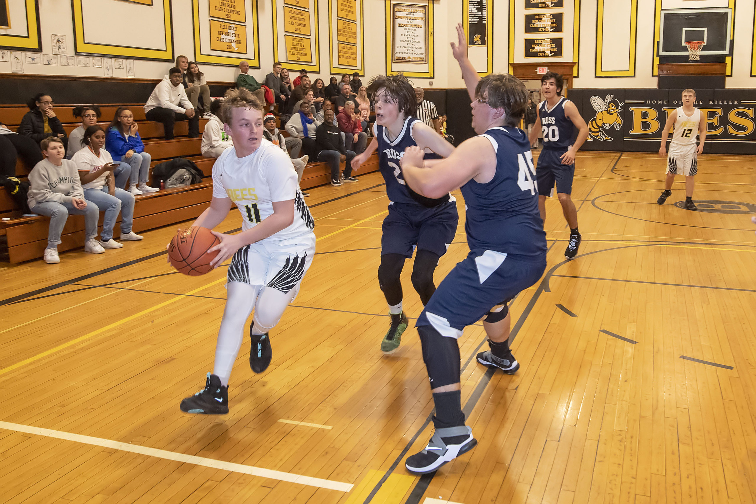 Bridgehampton's Dylan Fitzgerald is stopped at the baseline by a few Ross defenders.