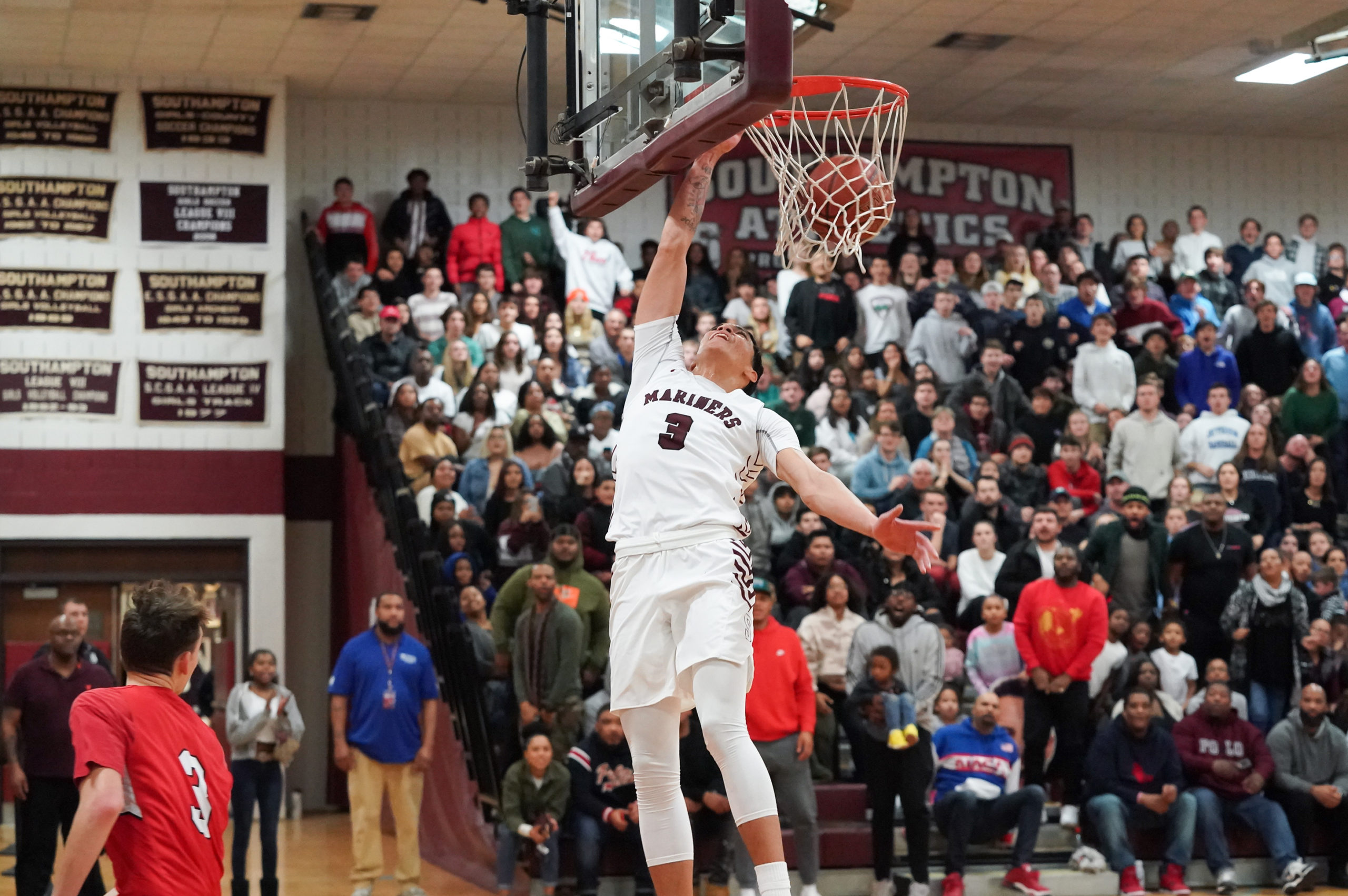 Southampton senior Dakoda Smith finishes a fast break with a dunk bringing the home crowd to its feet.