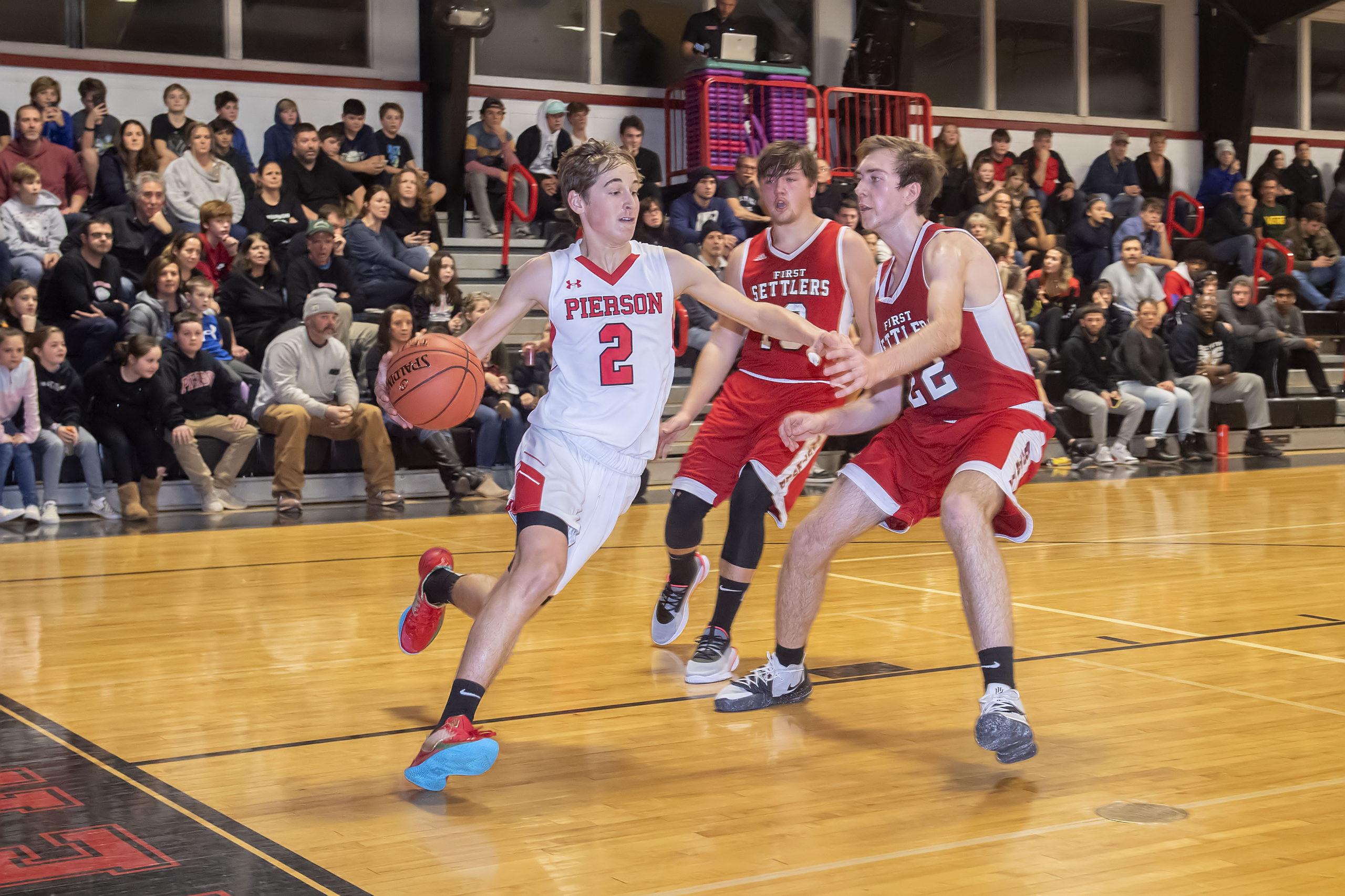 Pierson's Cecil Munchin tries to beat a pair of Southold defenders to the basket.