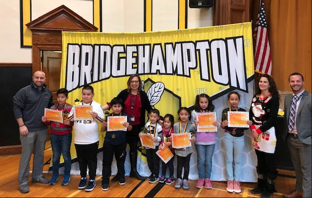 Bridgehampton School staff and administrators, Michael DeRosa,  Hamra Ozsu, Maria Reilly, and Michael Cox with students named Positive Behaviorial  Intervention and Support Student of the Month Award recipients,  Gonzalo Alvarez, Erick Alvarez, Kevin Tuba, Andy Cabrera, Emely Boch, Nahla Titus, Ashli Reyes and Alysson Pichon.Recipient Jan Carlos is not in the photo. 