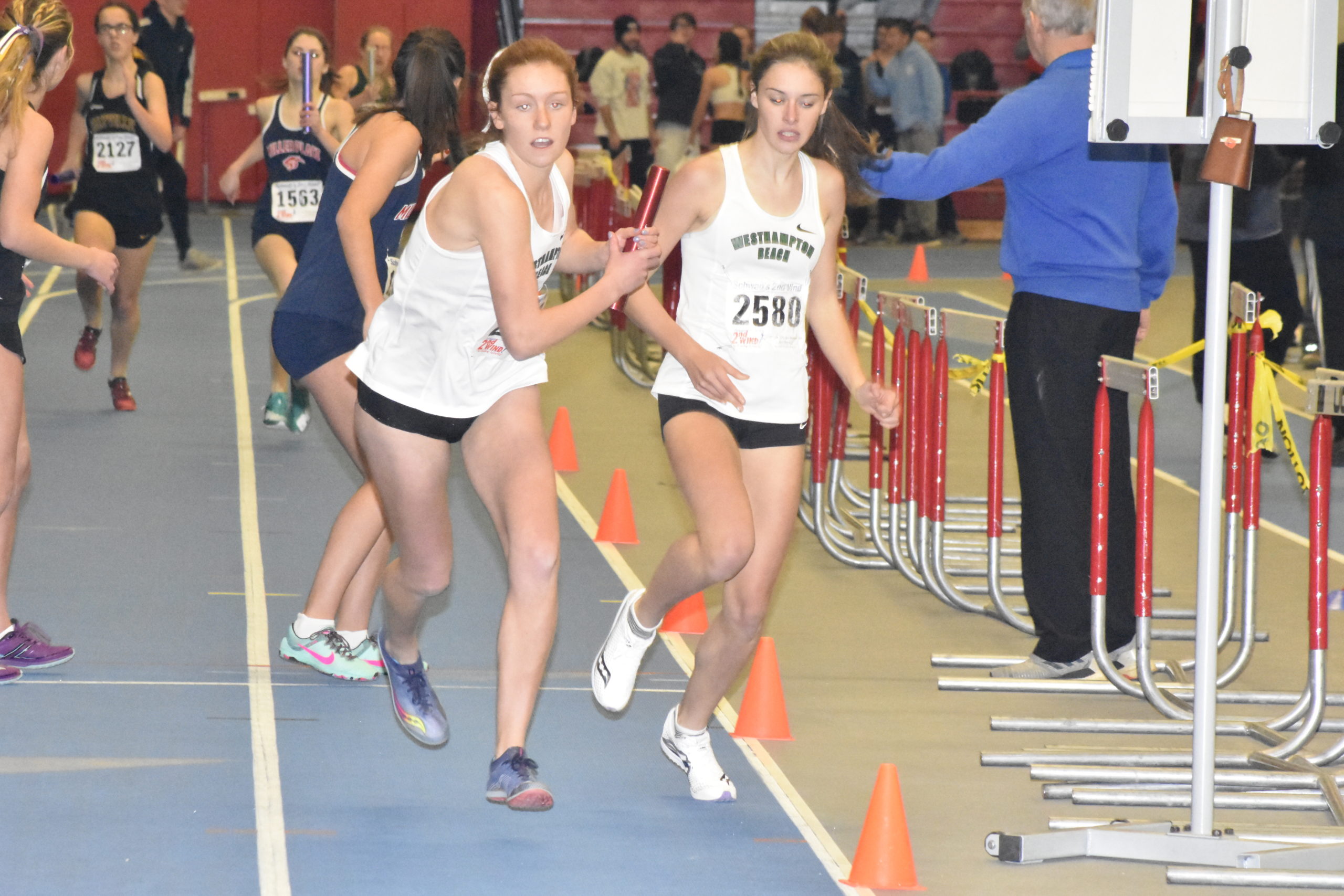 Sara Dunathan hands off to Jackie Amato in the 4x400-meter relay.