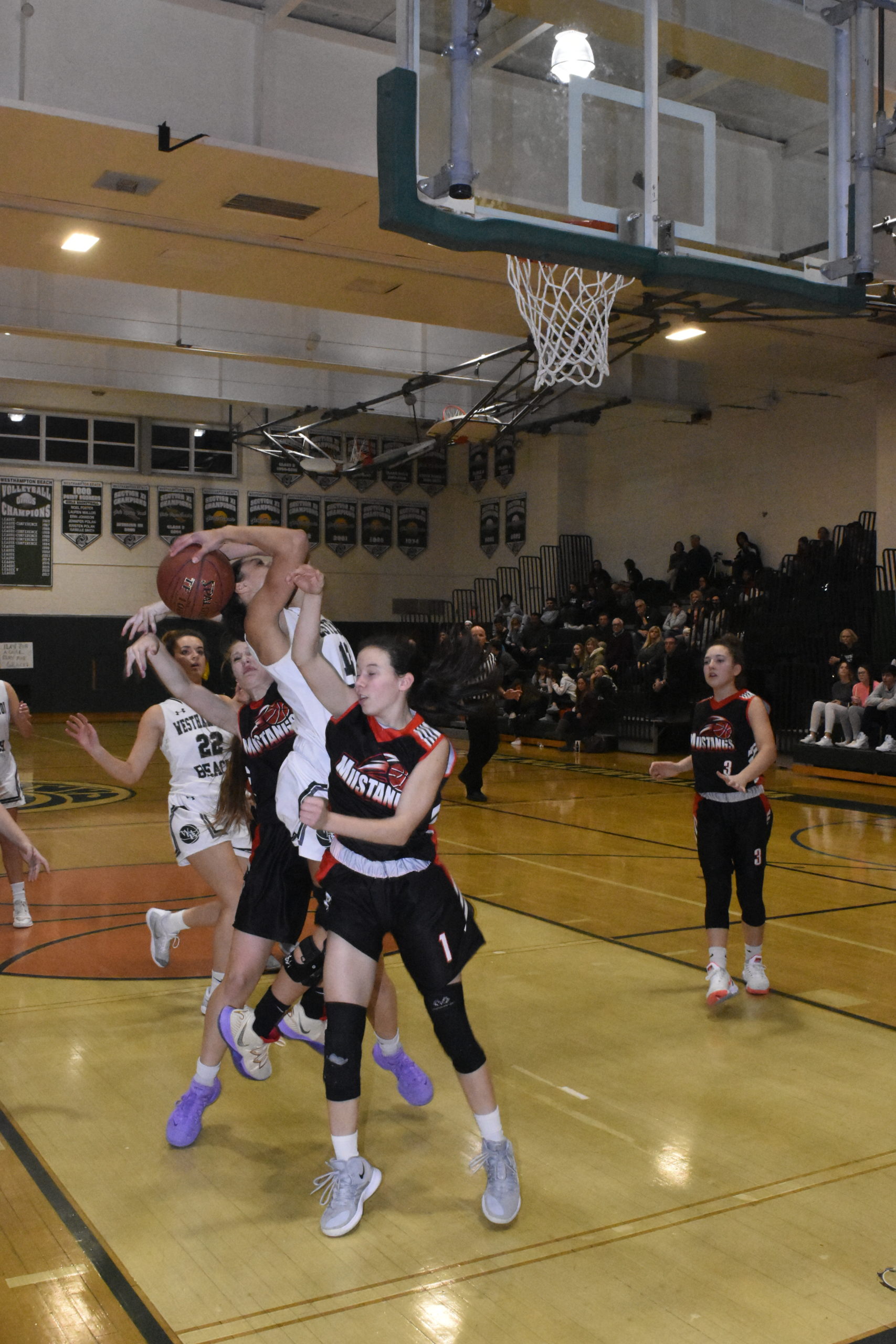 Westhampton Beach senior Layla Mendoza was somehow able to score on this play despite the ball being fouled and the ball being behind her head as she shot it.