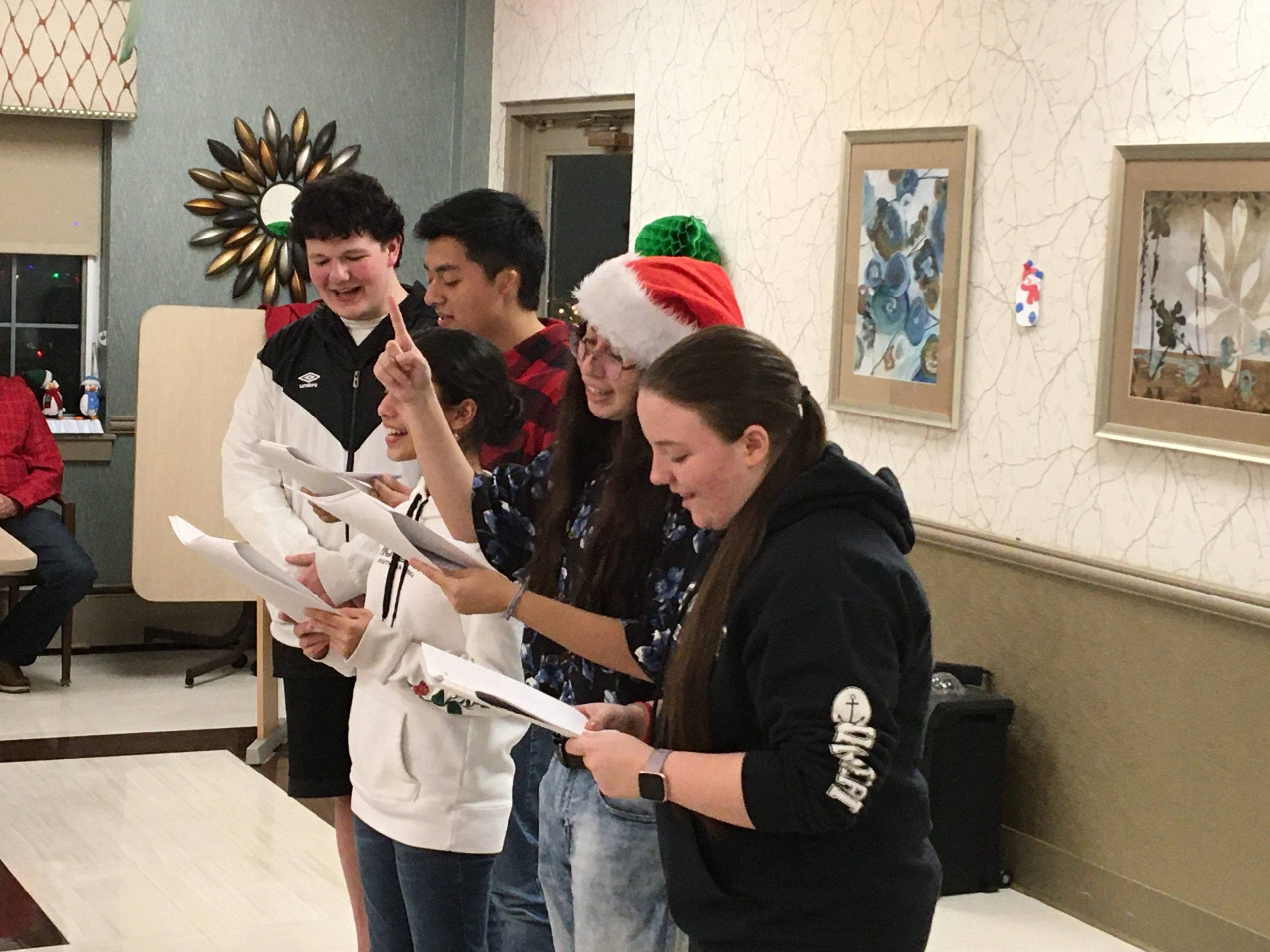 Members of the Hampton Bays High School Leo Club joined the Riverhead Lions Club on December 17 to sing Christmas carols and spread holiday cheer at the Acadia Center in Riverhead. From left, Dylan Abbott, Chris Lopez, Tara Lauther, Jennifer Quantano and Holly Anderson.