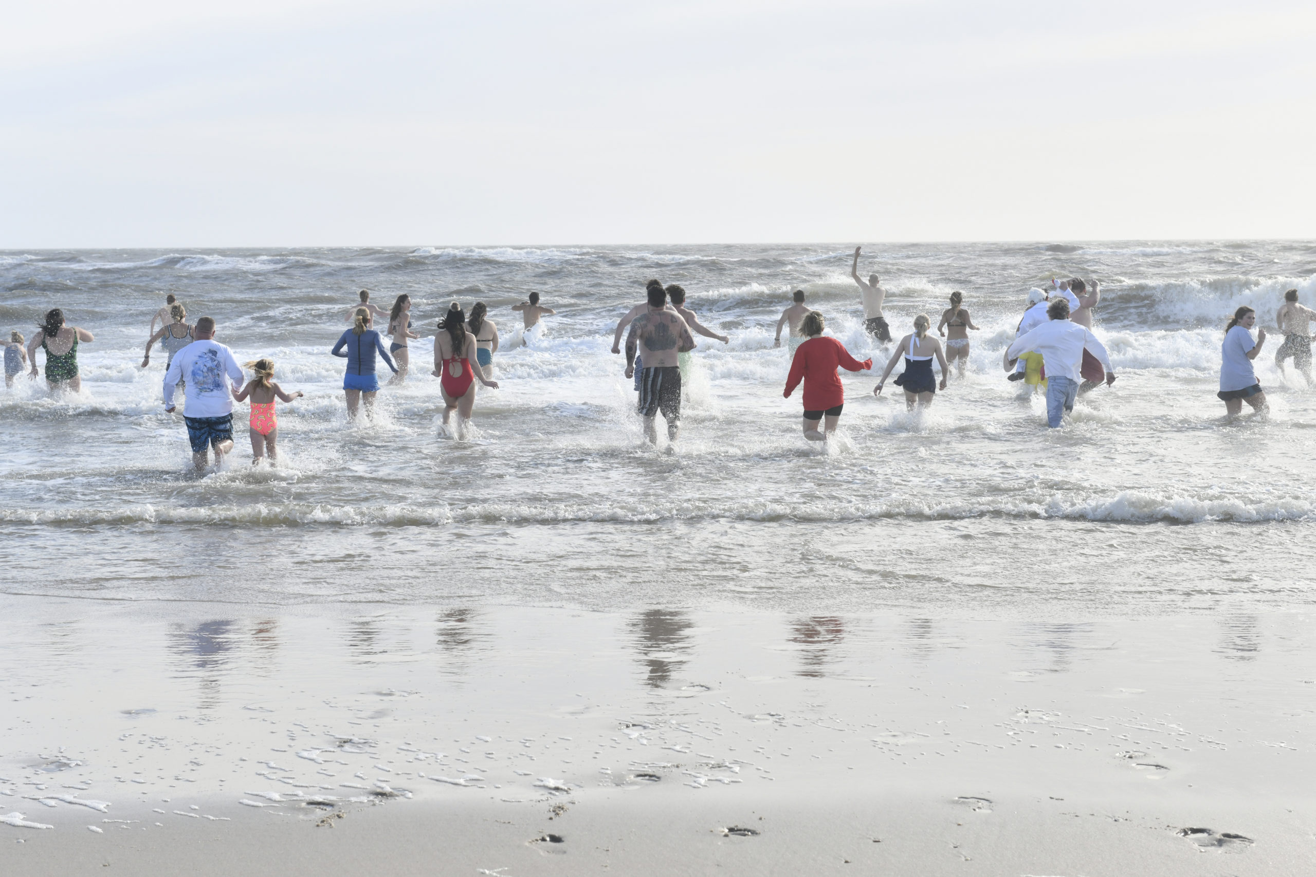 Plungers head into the water on Saturday afternoon at Rogers Beach.