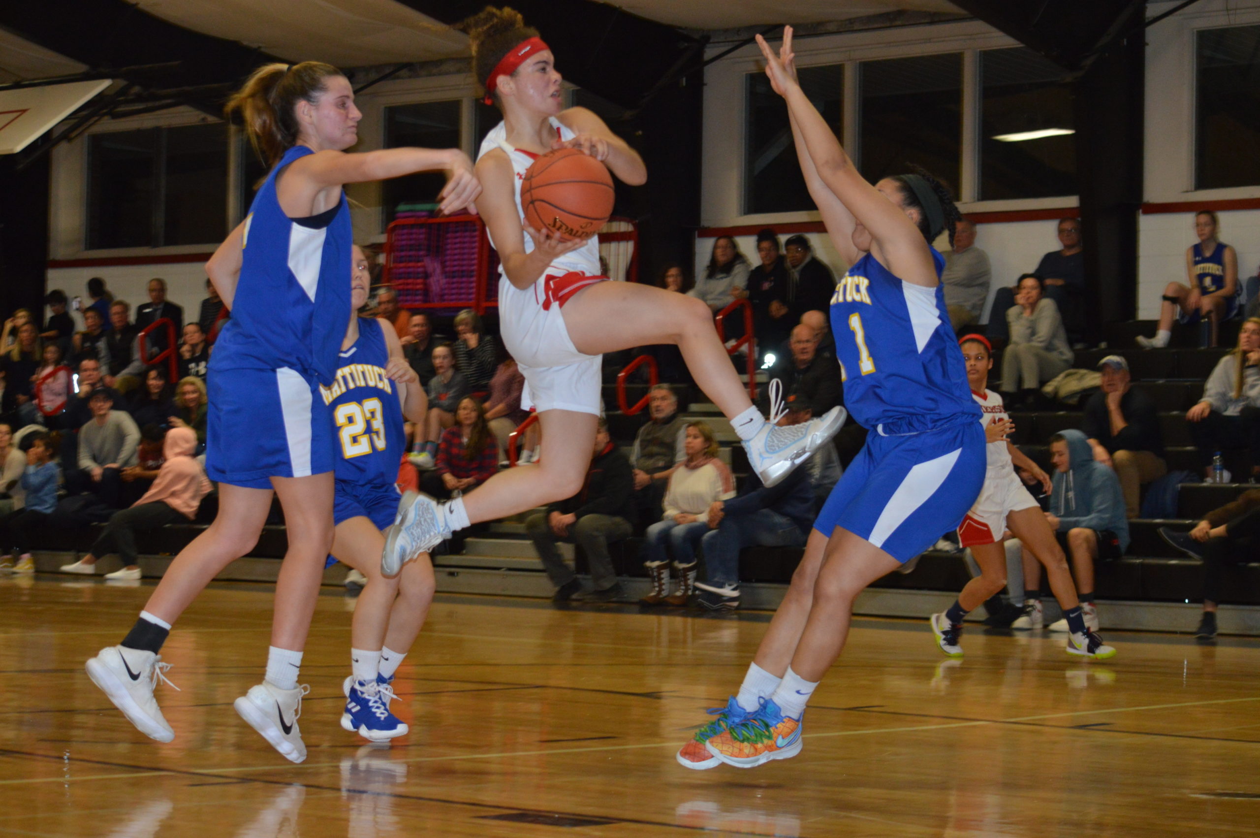 Lady Whaler Chastin Giles tries to take on a number of Mattituck defenders.