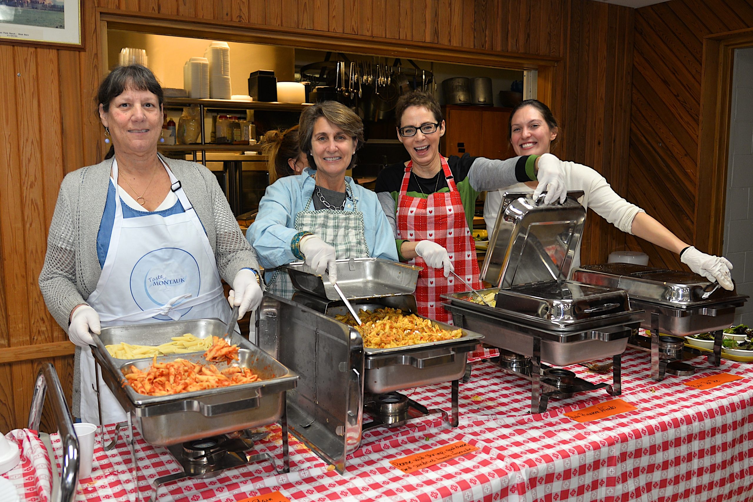 A pasta dinner fundraiser took place at the Montauk firehouse on Saturday to benefit the Robert R. Fisher scholarship fund. Dishing out the pasta were, from left, Donna DiPaolo, Judith Pfister, Patricia Byrne and Nicole George. KYRIL BROMLEY