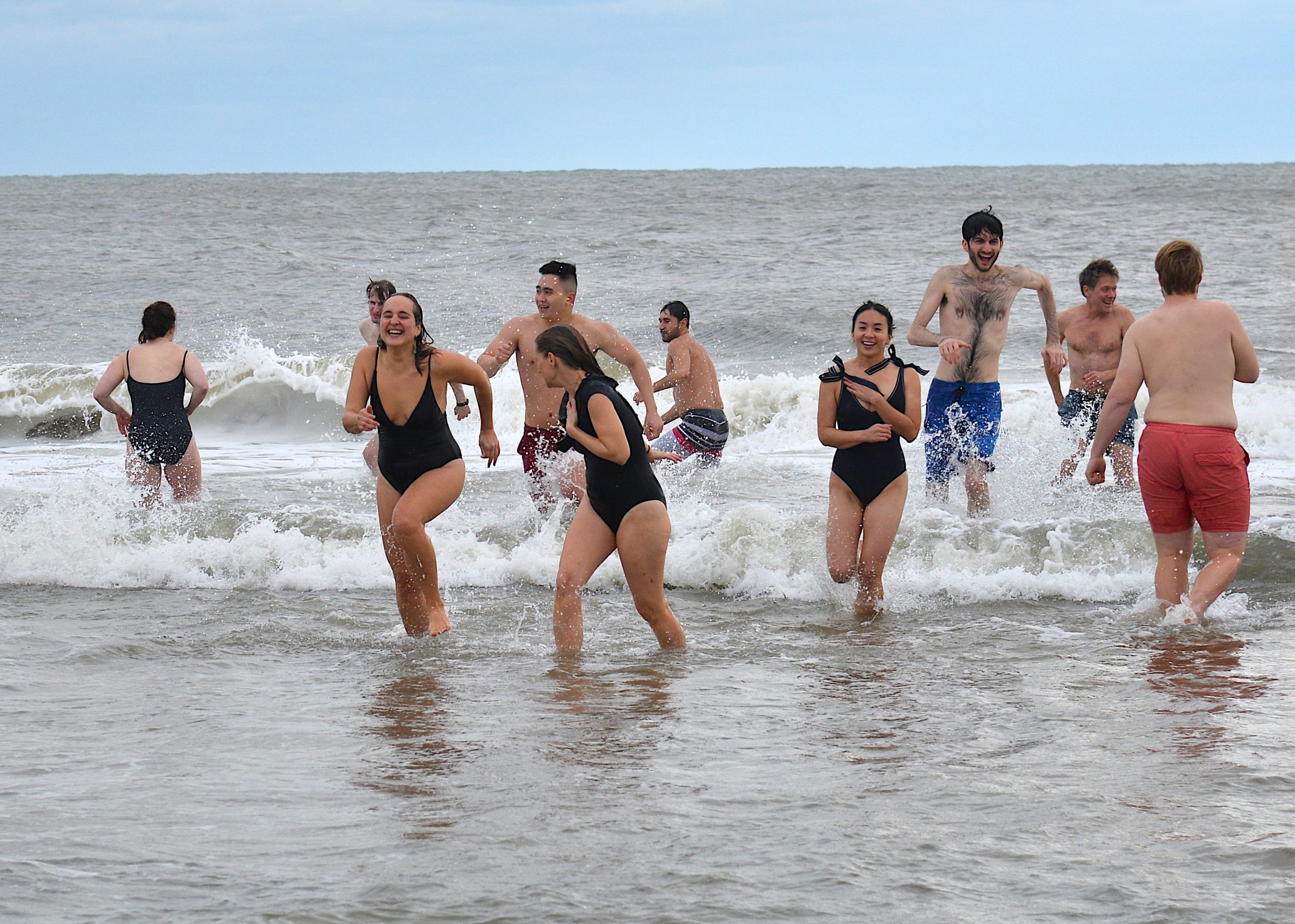 Dozens of brave souls gathered on New Year's Day for the annual polar plunge at a Wainscott beach, organized by the Seafood Shop. This year's event raised money for the Sag Harbor food pantry. KYRIL BROMLEY