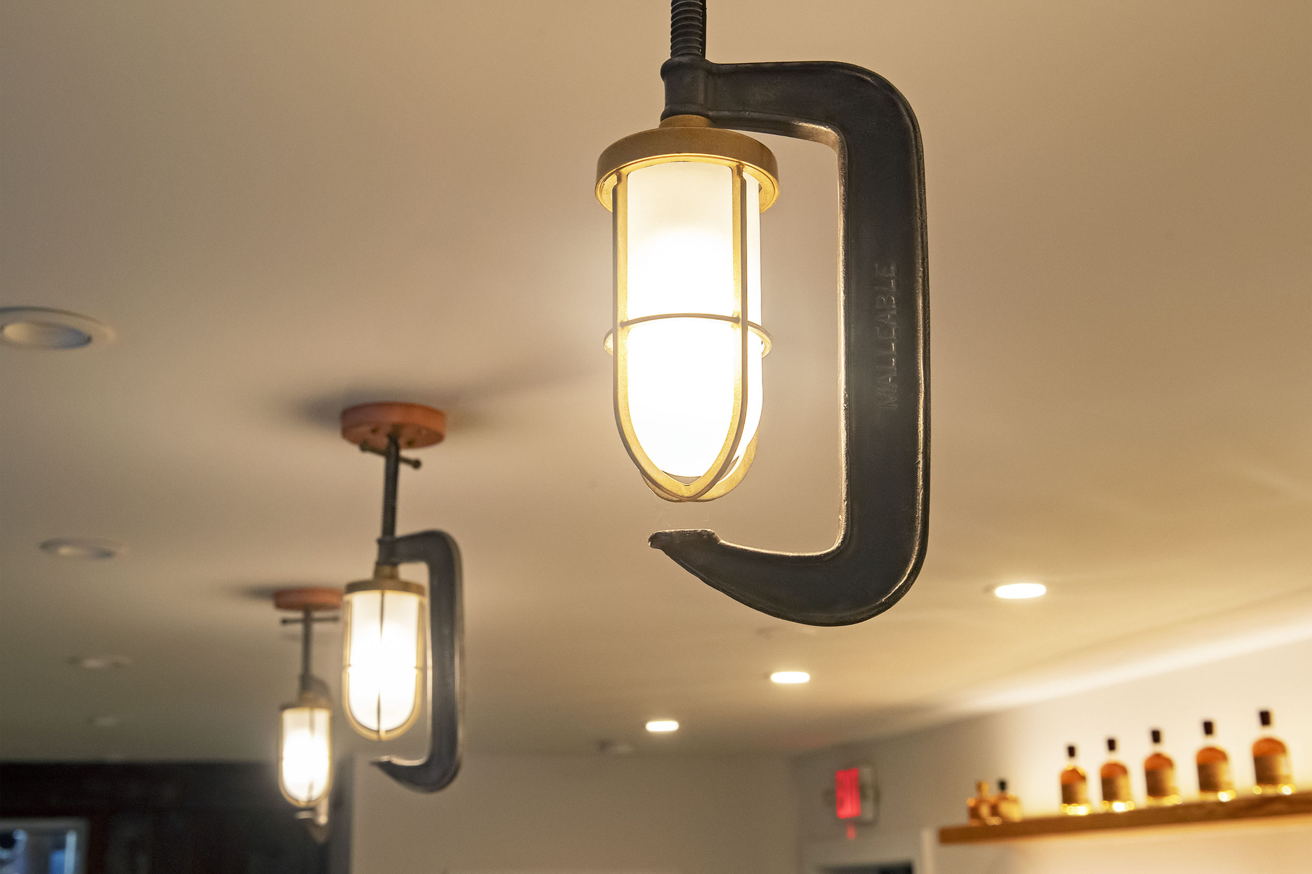 Repurposed clamps create lighting in the tasting room. MICHAEL HELLER