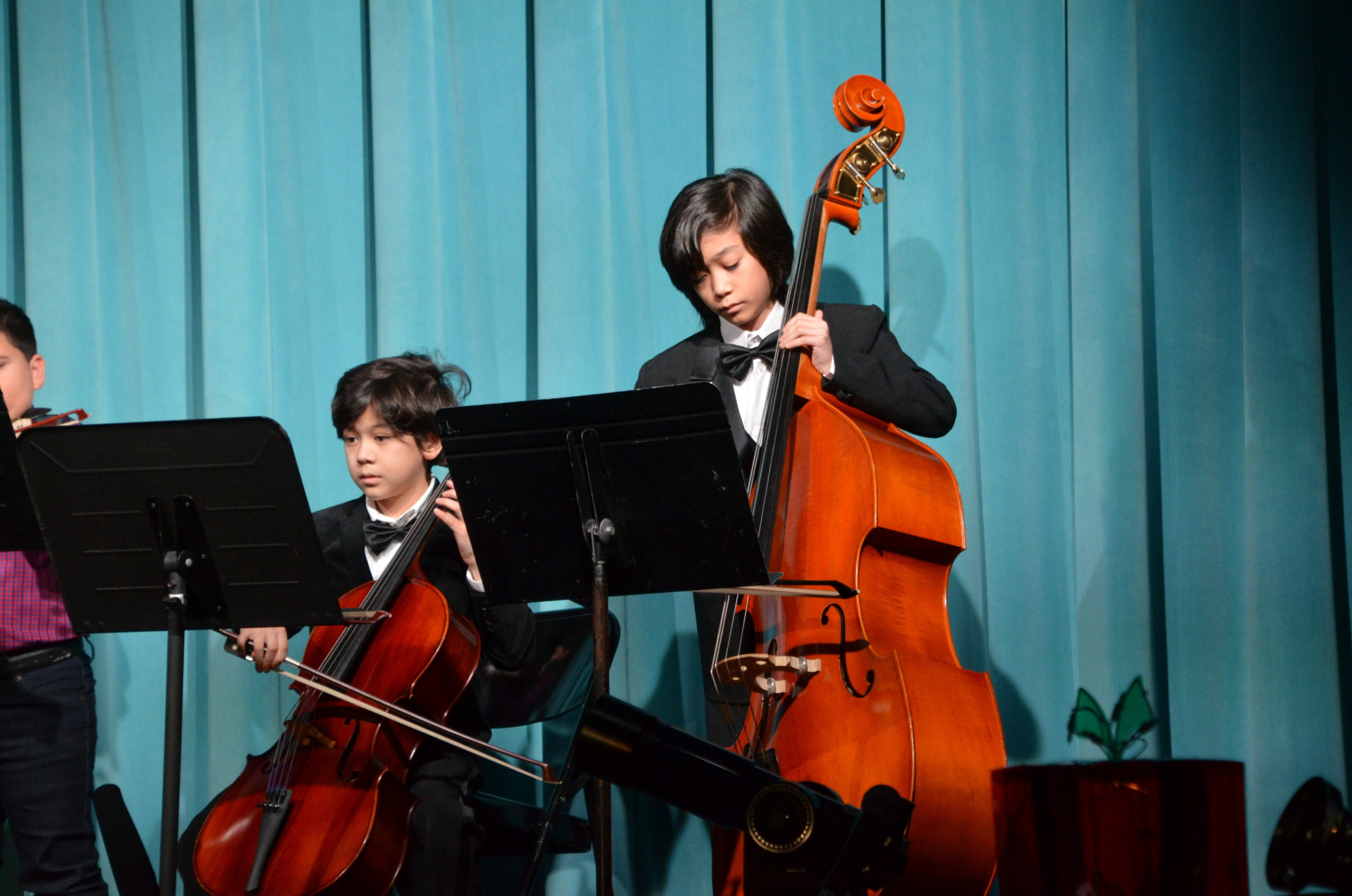 Members of the Our Lady of the Hamptons School string ensemble Giovanni Tumino and Luke Tumino perform at the Christmas show. 