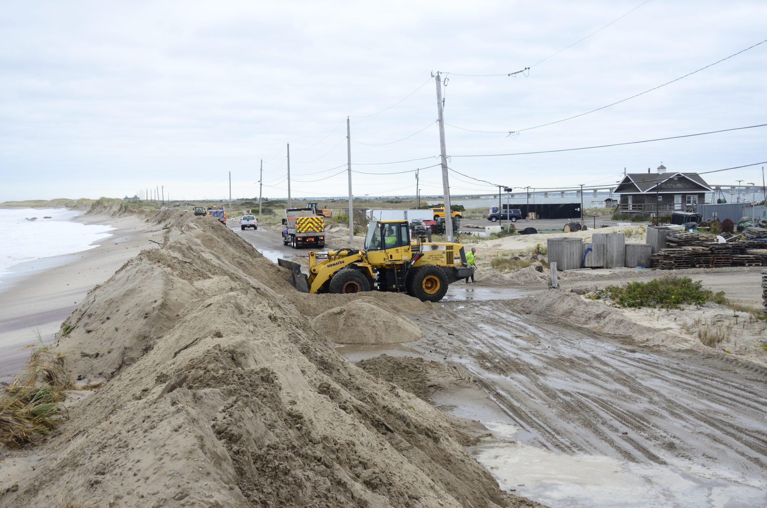 Crews responded to a washover on Dune Road in October after waves generated from a nearly stationary coastal storm pounded the coast. GREG WEHNER