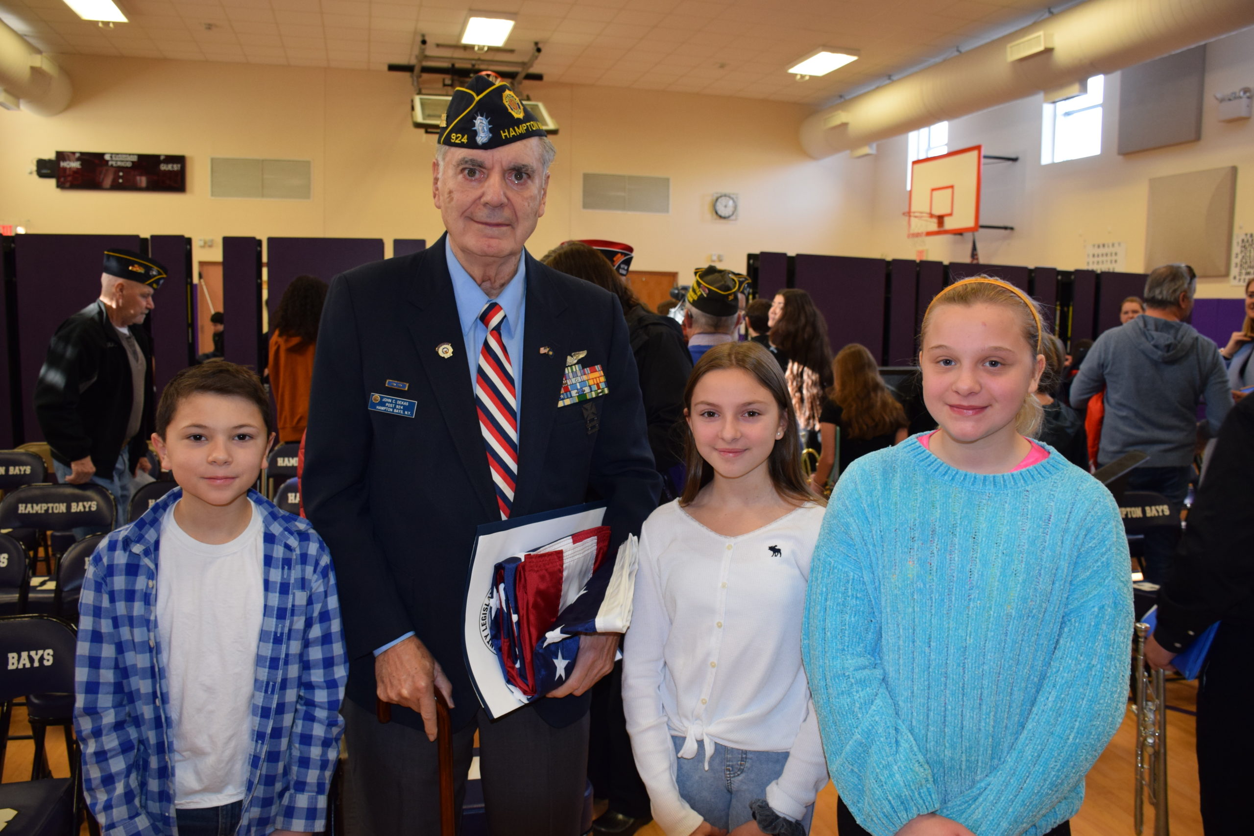 Hampton Bays students, including  Nico Carone, Keira Nappi and Adriana Tapfer, honored U.S Air Force veteran John Constantine Dekas during a flag ceremony on January 24.  