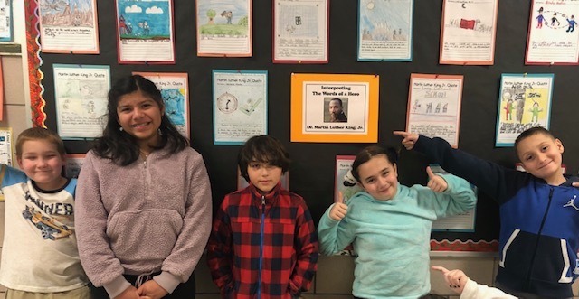 Cary Wyllie’s fifth-graders, from left, Liam O’Connor ,Kayden Mulvane, Londhen Escobar, Joaquin Jimenez and Nico Cortina, at East Quogue Elementary School created artistic interpretations of famous quotes by Martin Luther King Jr. 