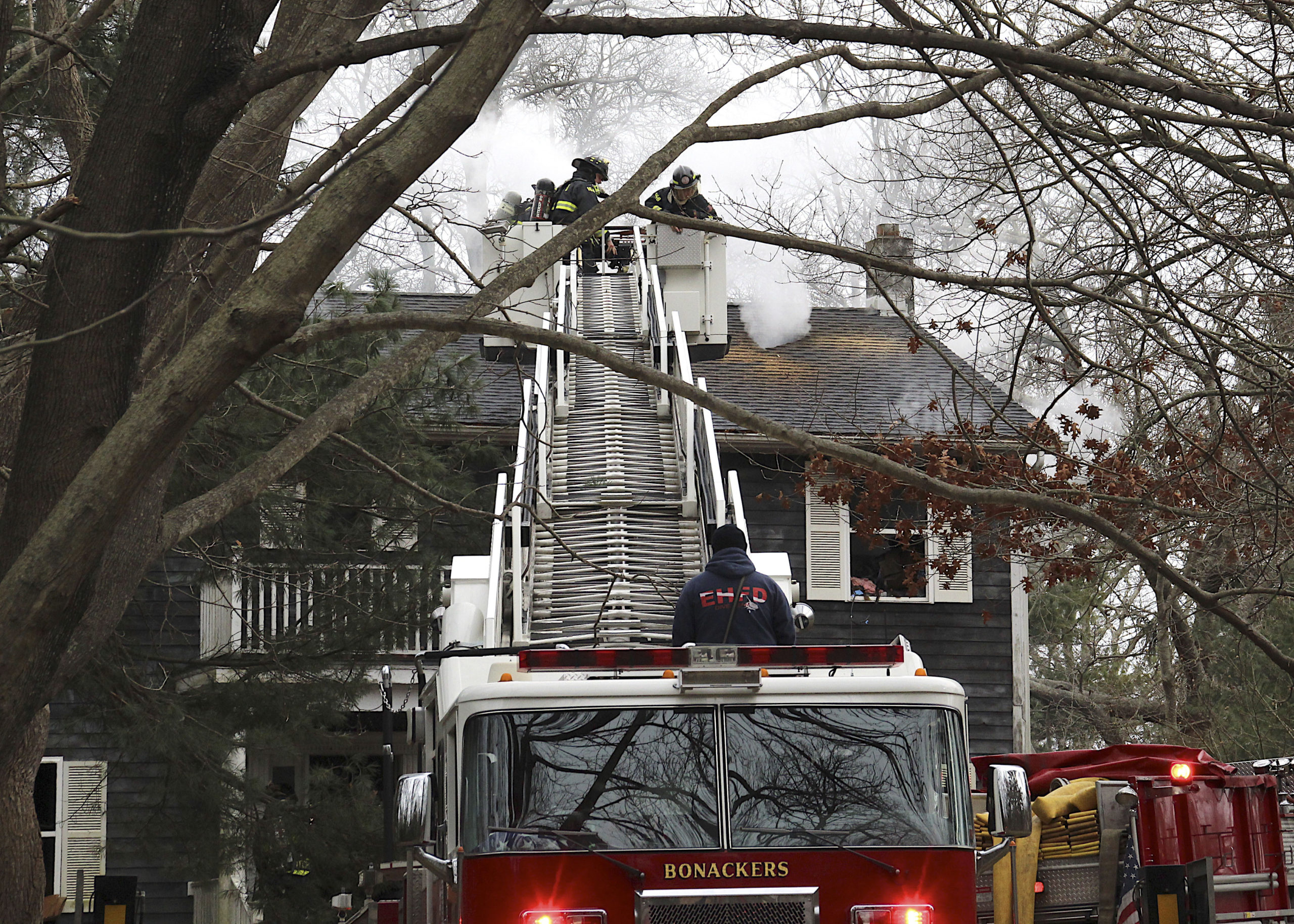 Firefighters at 38 Cove Hollow Road in East Hampton on Saturday.         KYRIL BROMLEY