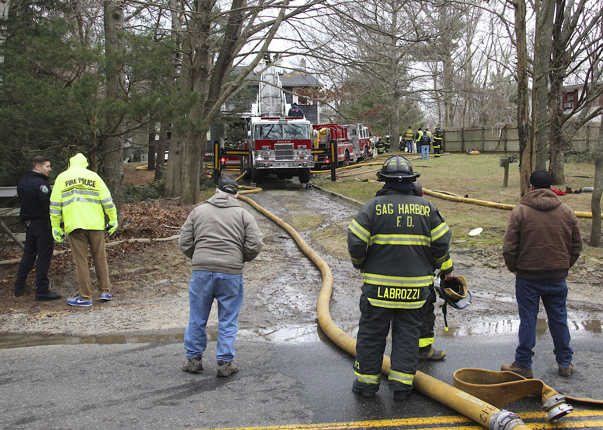 Firefighters at 38 Cove Hollow Road in East Hampton on Saturday.         KYRIL BROMLEY