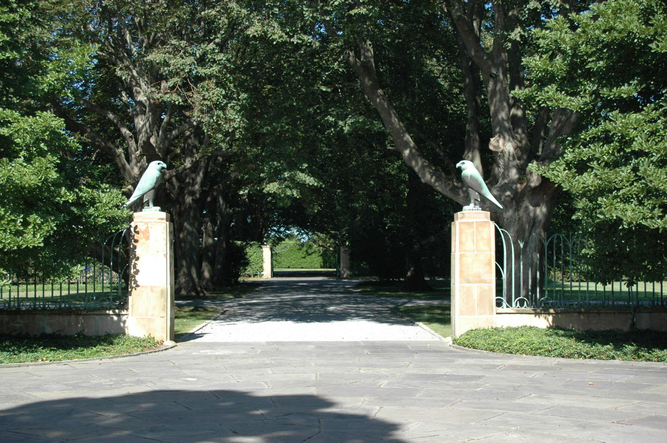 Looking toward Halsey Neck Lane from courtyard with bronze falcons on crab orchard pillars attached to bronze fence  ANNE SURCHIN