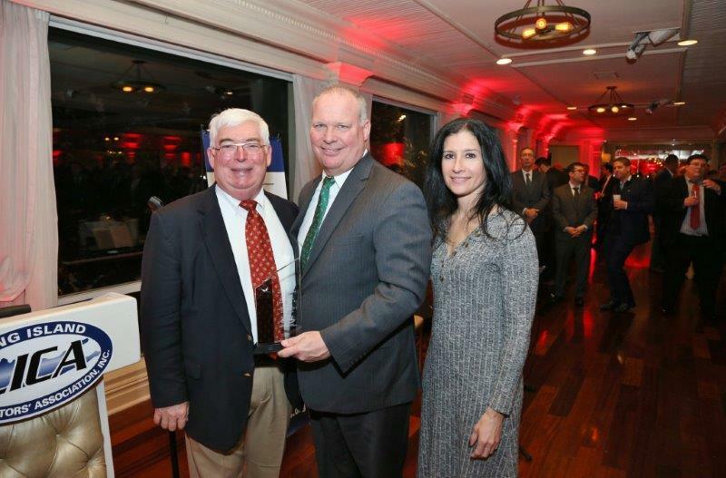 Kevin McDonald, left, of the Long Island Nature Conservancy was presented with the Long Island Contractor Association's 2019 Partnership Award for the Conservancy's efforts in getting Suffolk County clean water and sewer expansion initiatives passed. Marc Herbst and Sheryl Buro of LICA made the presentation at the group's annual holiday party. 
