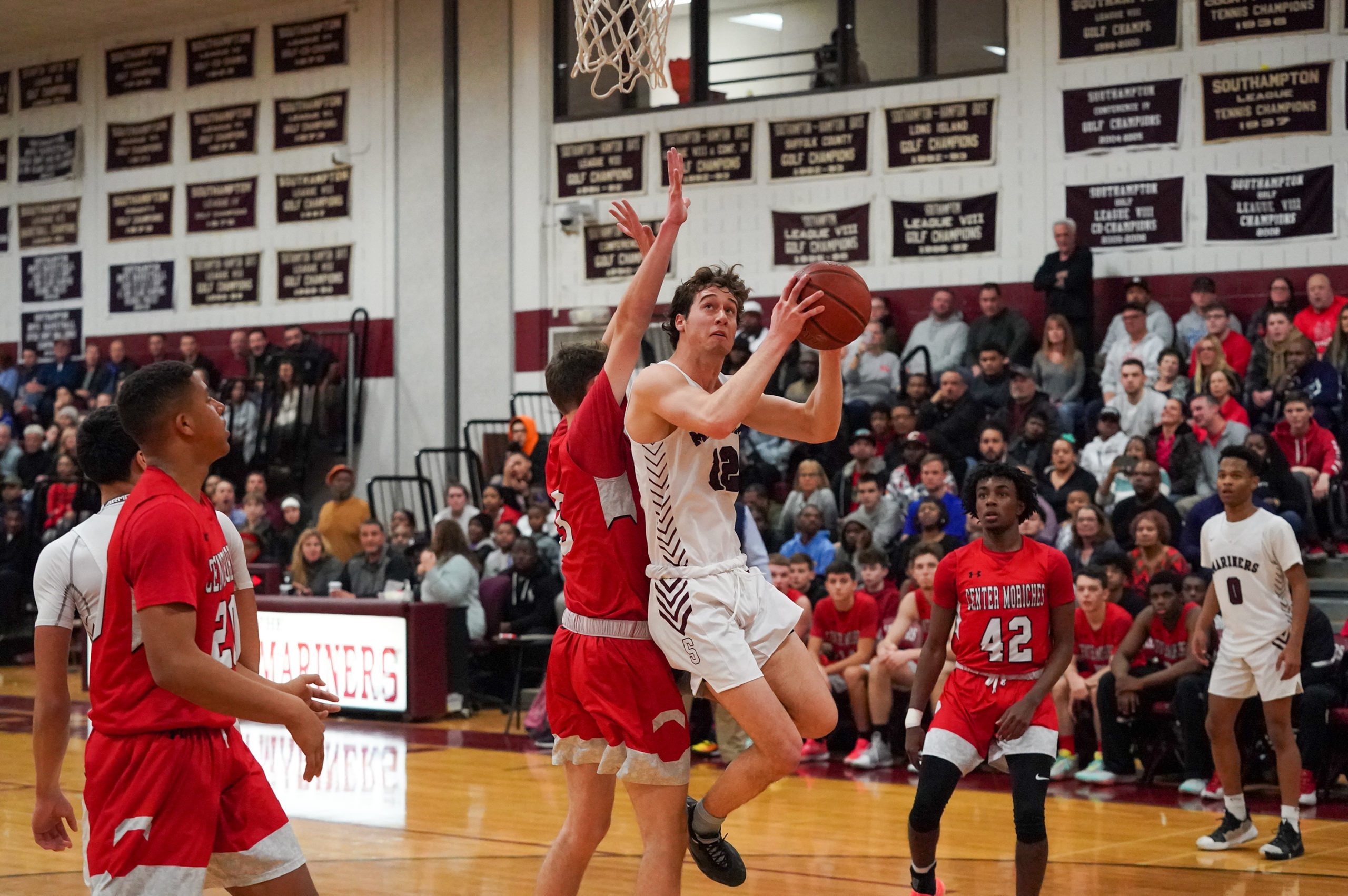 Southampton senior James Malone absorbs some contact while going up with a shot.