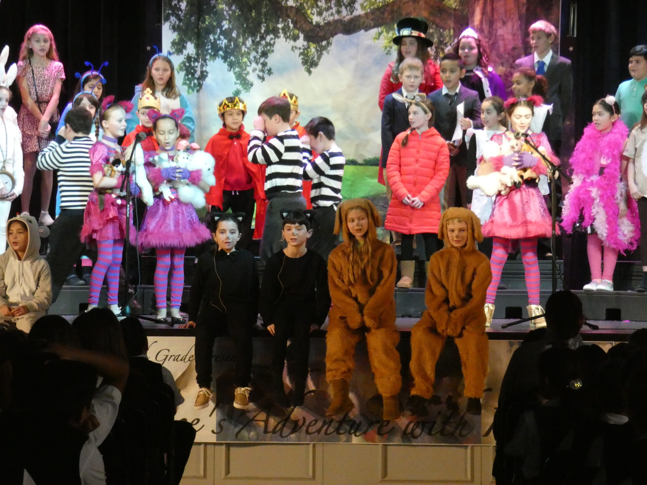 Fourth-graders at Our Lady of the Hamptons School   presented a special assembly “Alice’s Adventures with Idioms,” a play based on English grammar in song and dance.