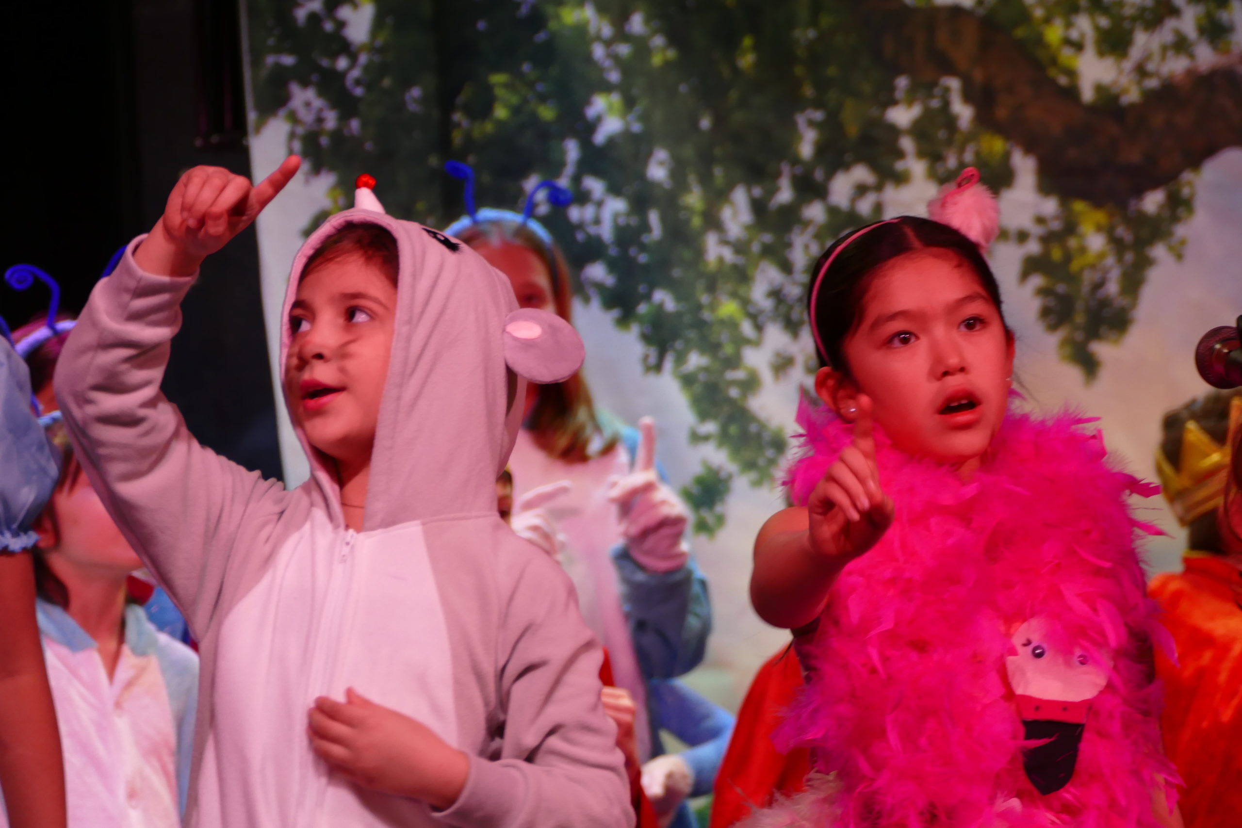 Fourth-graders at Our Lady of the Hamptons School, including Phoebe Sosa and Scarlett Macias, presented a special assembly “Alice’s Adventures with Idioms,” a play based on English grammar in song and dance.