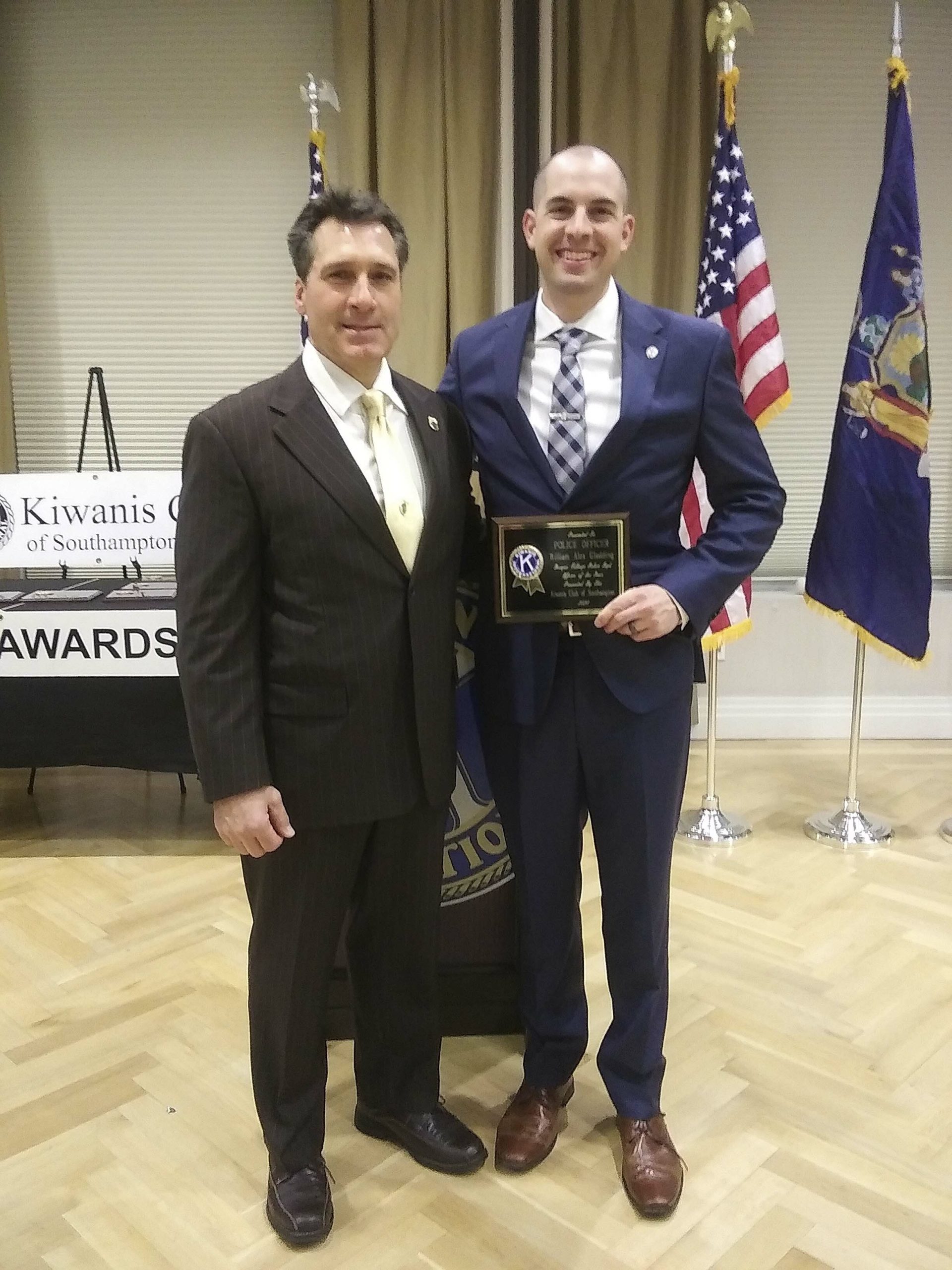 Quogue Village Police Officer William A. Gladding, right, is presented with the Southampton Kiwanis Club Police Officer of the Year Award from Quogue Village Police Chief Christopher Isola at Atlantis Banquet and Events in Riverhead on Friday evening. This is the Kiwanis Club's 50th annual ceremony recognizing local law enforcement in their individual departments. SONDRA ROSANTE
