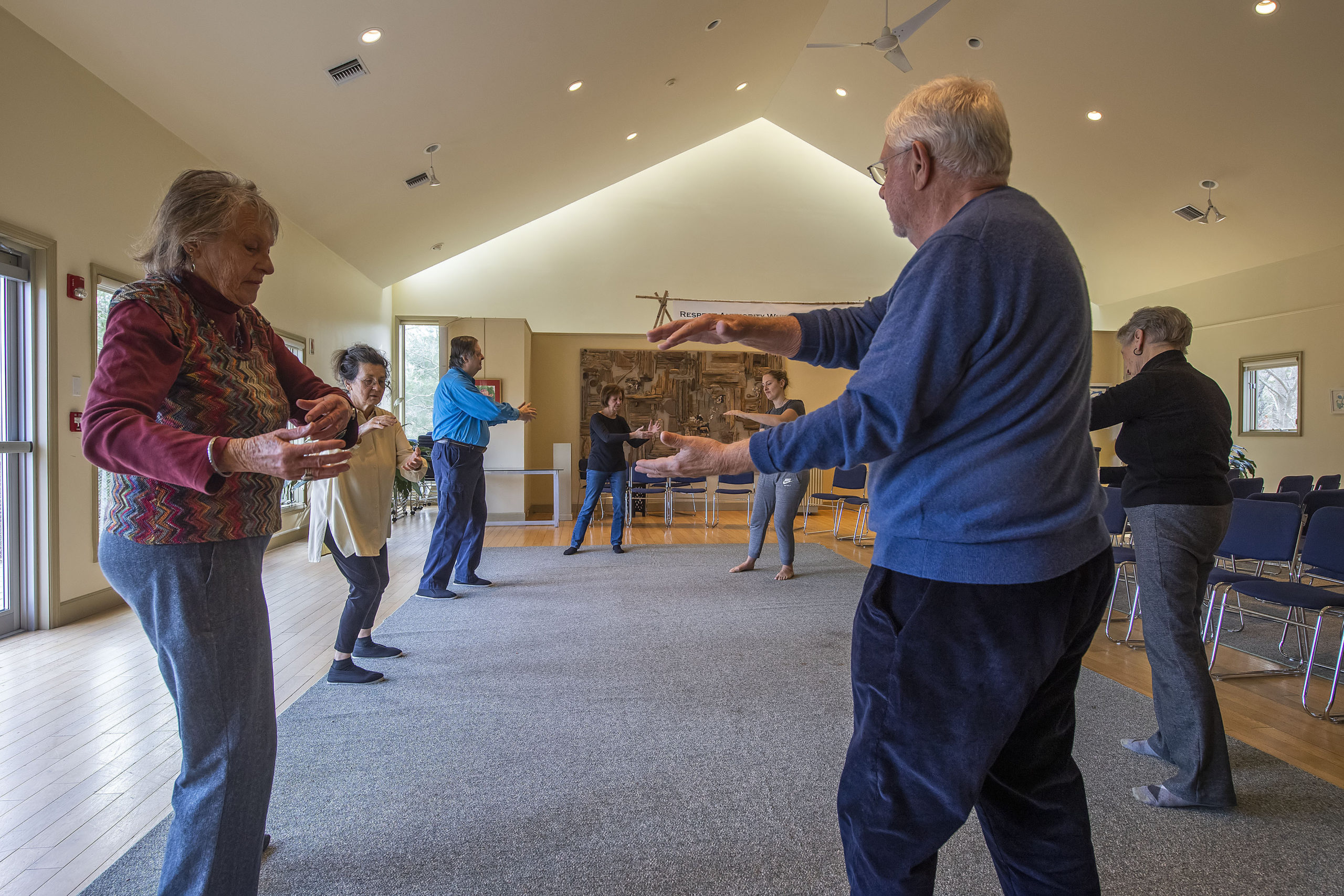Instructors Tina Curran and Steve Flores, second and third from left, lead a small group as they practice Qi Gong at the Universalist Unitarian Church of the Hamptons on Sunday, January 12.  MICHAEL HELLER