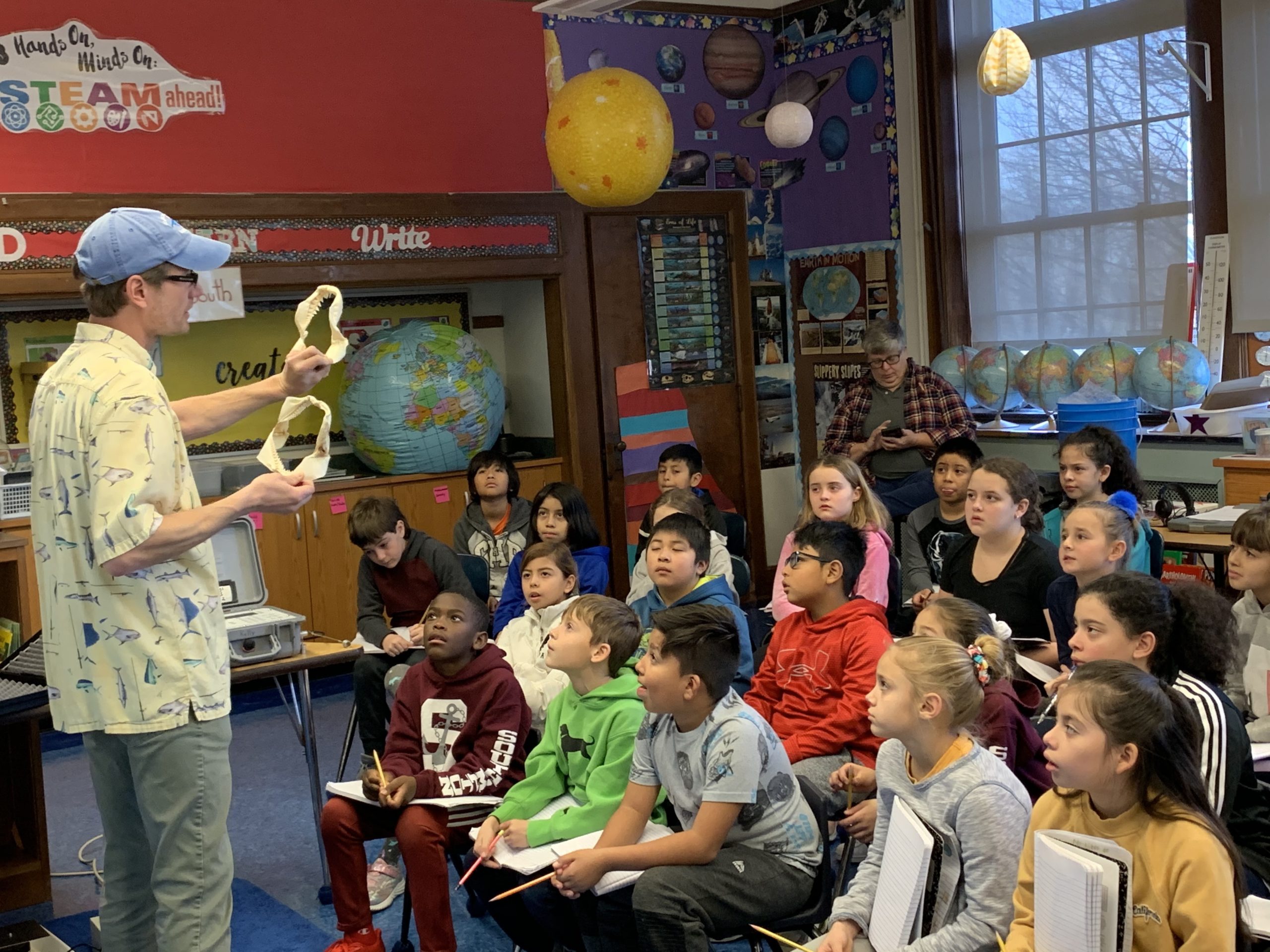 Southampton High School marine science teacher Gregory Metzger spoke to third- and fourth-grader about his research on sharks. 