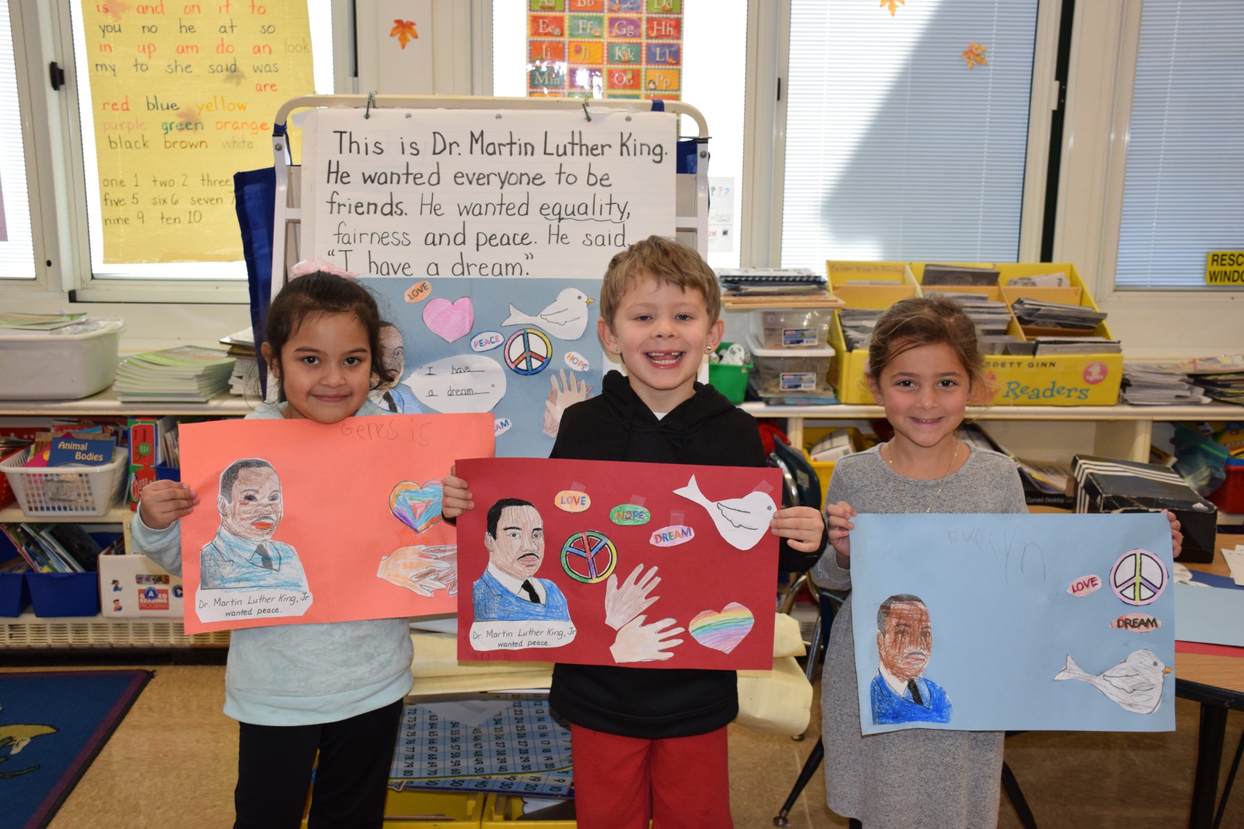 Patricia DeCicco’s kindergartners at Westhampton Beach Elementary School learned about the life of Dr. Martin Luther King Jr. on Jan. 17. Following the discussion, the students, including, from left, Genesis Lopez Castellanos, Raiden Komarovskij and Evelyn Bennett,  designed posters depicting what they learned about the civil rights leader. 