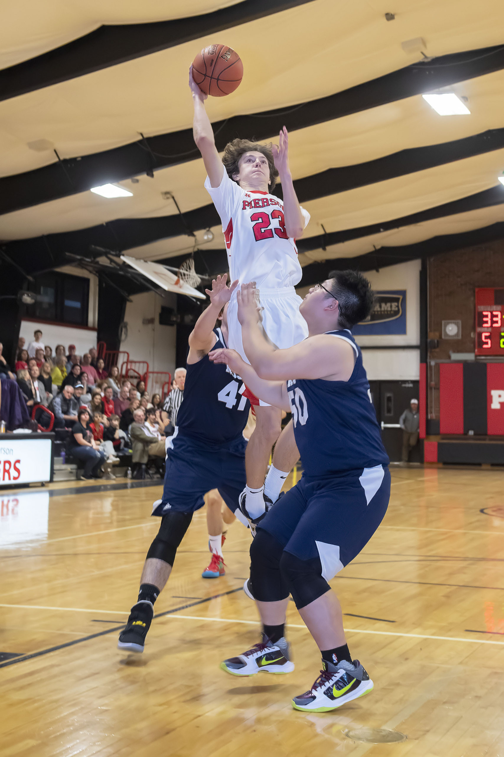 Pierson's George Summers splits a pair of Ross defenders and goes up for a layup.