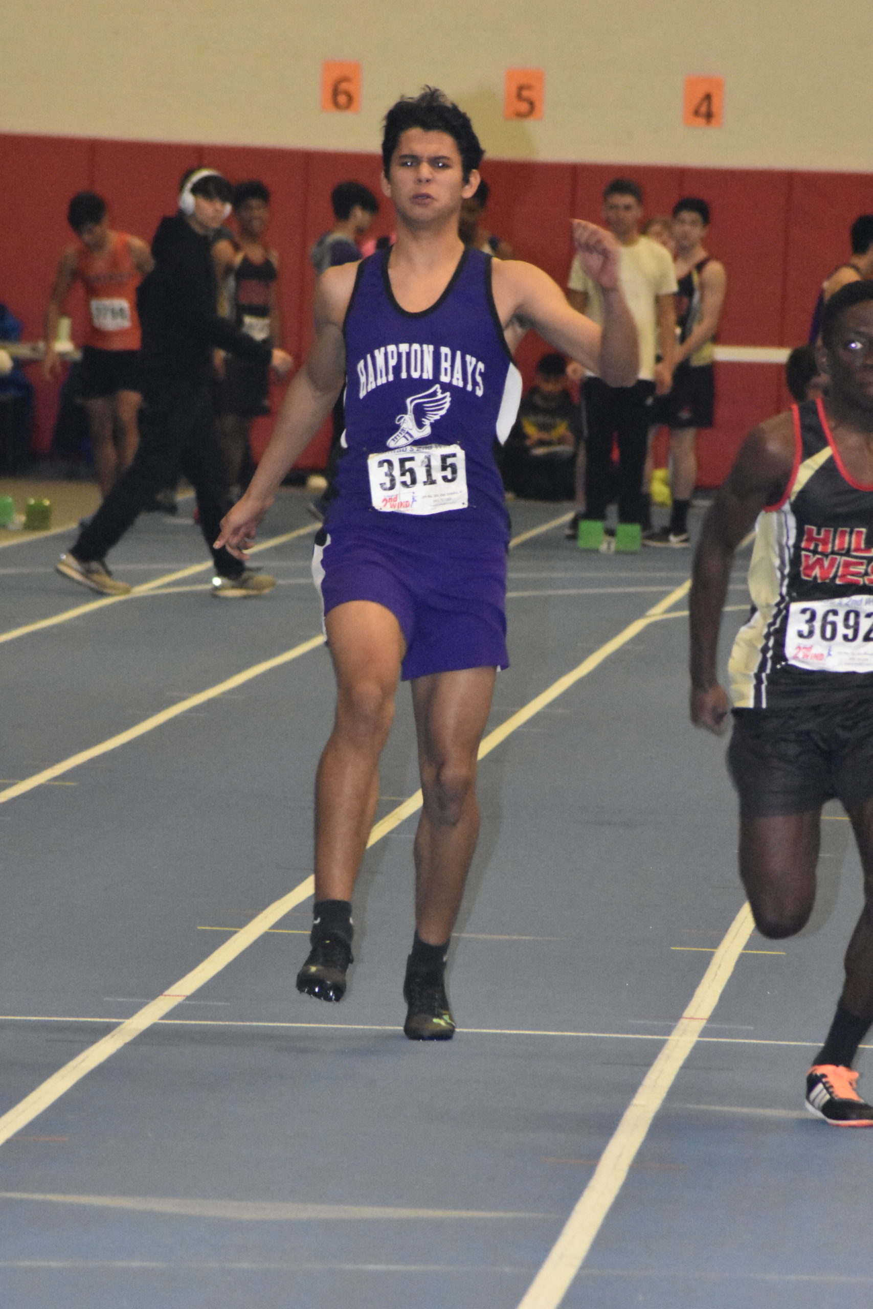 Hampton Bays junior Darwin Fernandez pulls up lame in the 55-meter dash. He wound up pulling his hamstring and has to scratch himself from the 600-meter run.