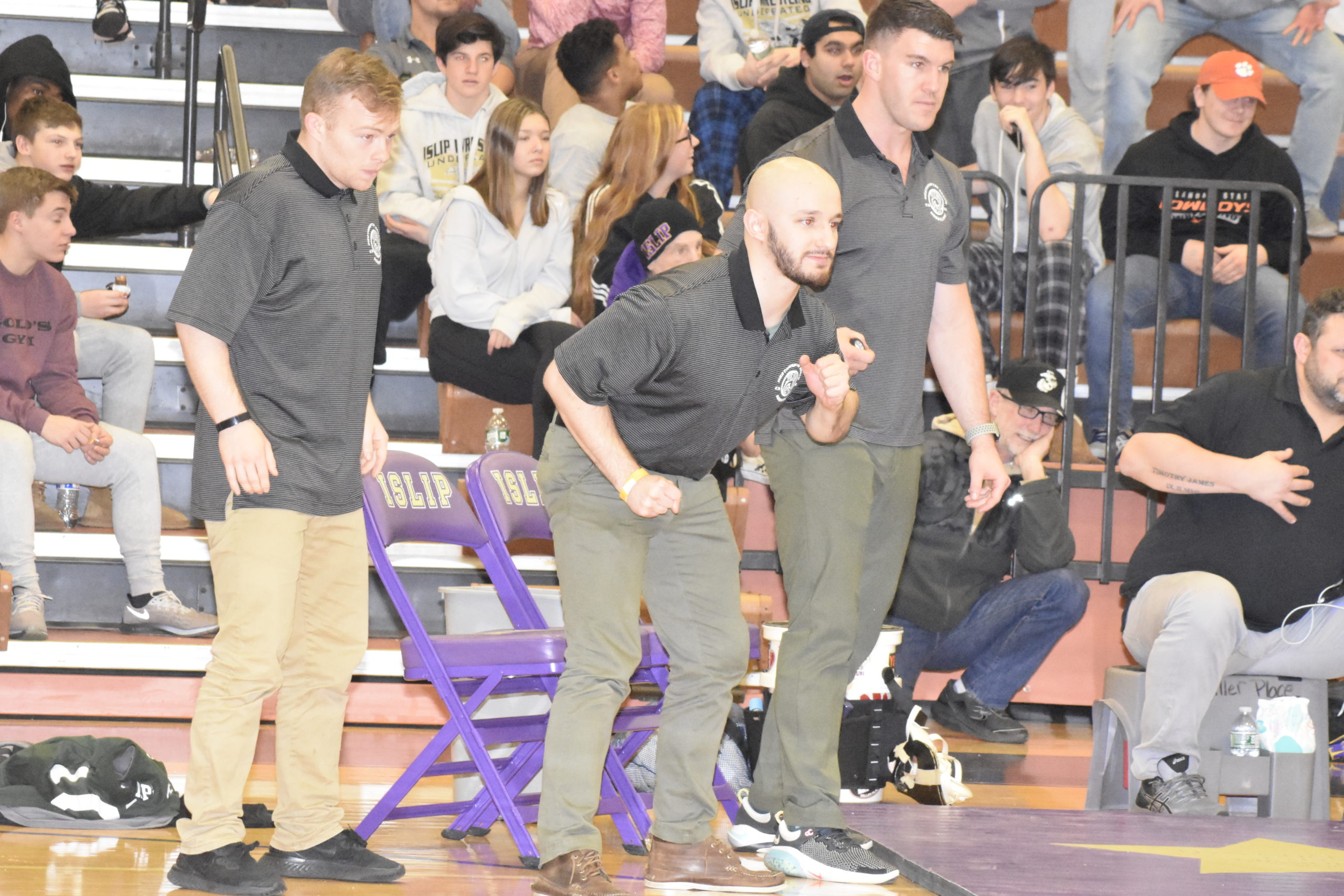 Westhampton Beach coaches, from left, Pete DeTore, Andrew Petroulias and Connor Miller look on as Jason Montagna nearly pins Thomas DiResta.