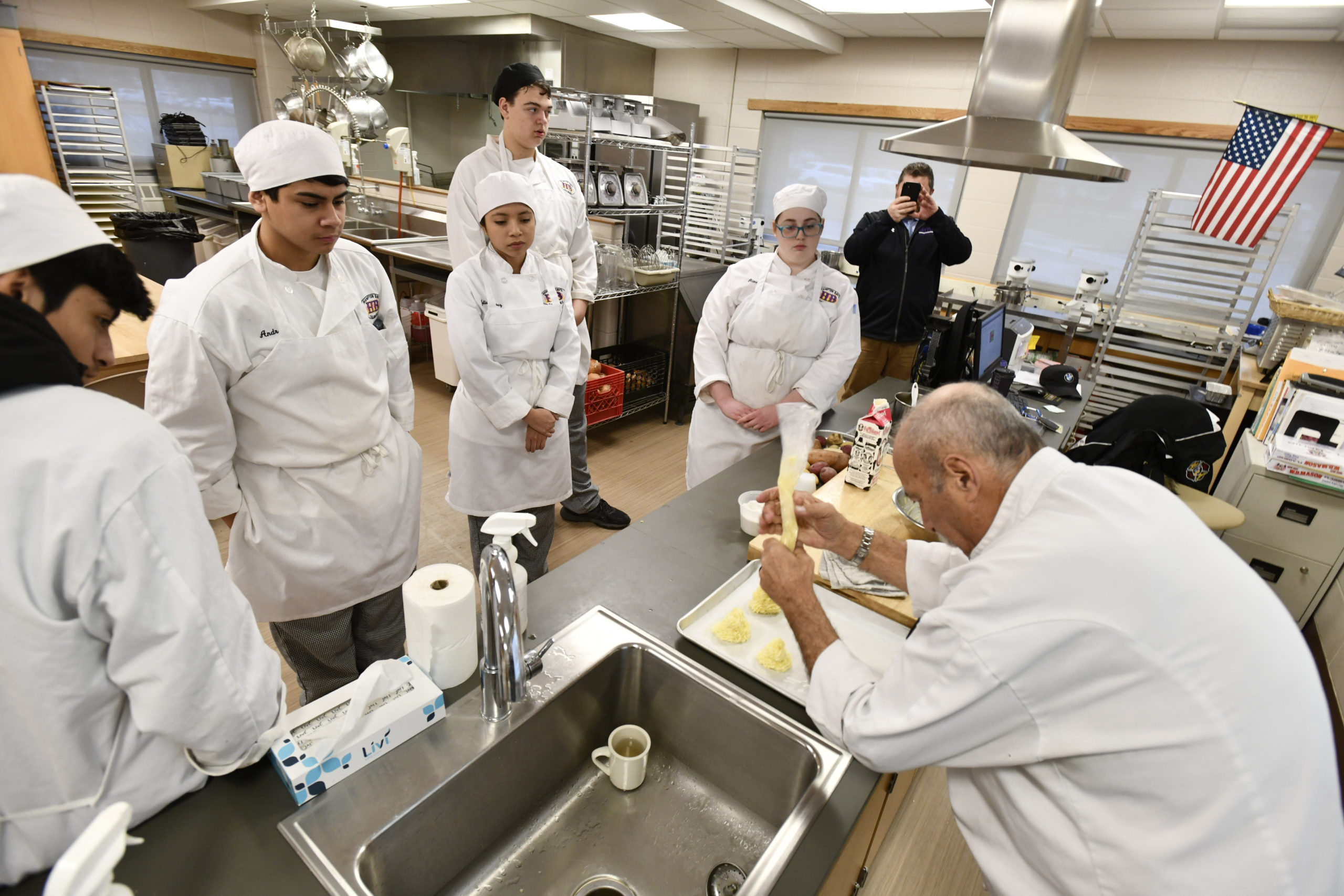 Chef Larry Weiss demonstrates the assignment during the culinary class at Hampton Bays High School on Thursday, February 6. DANA SHAW