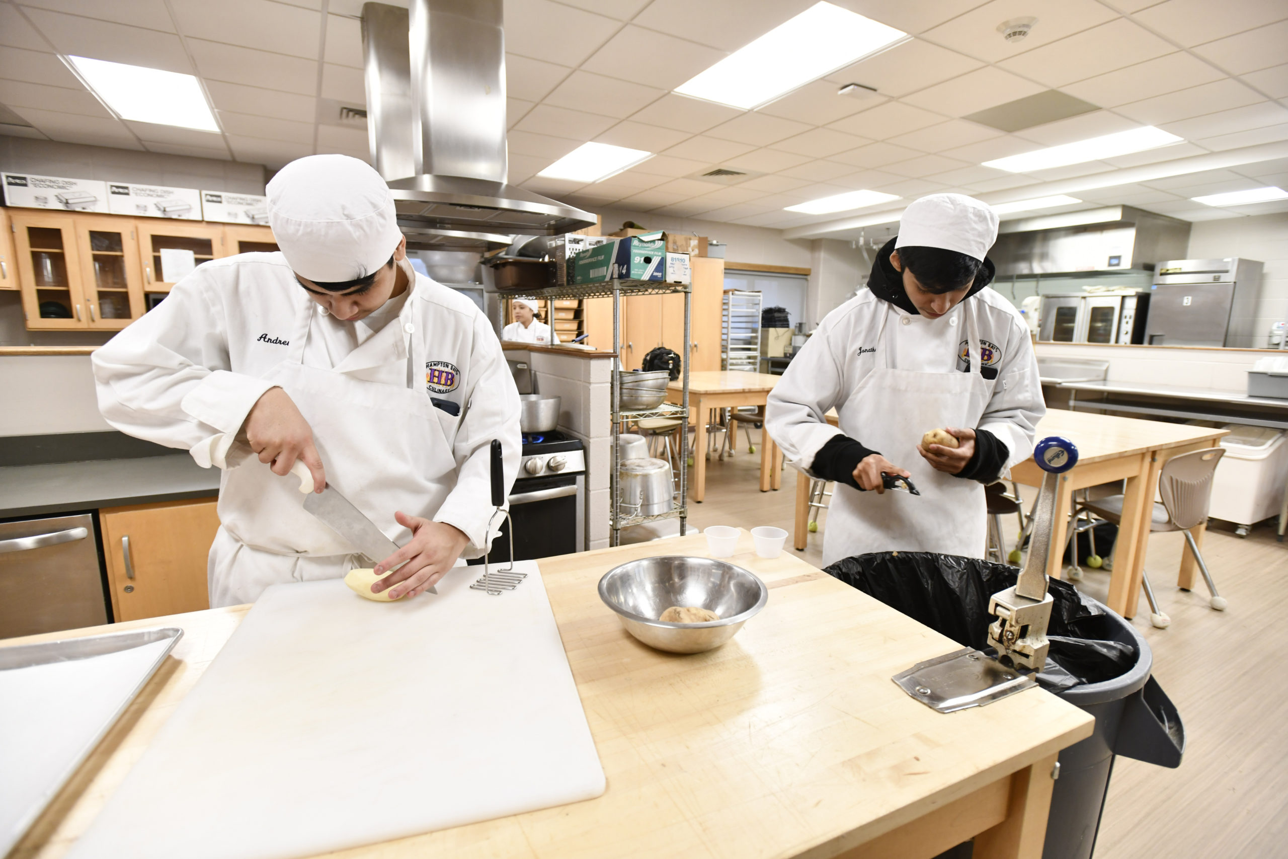 Students Andrew Avila and Jonathan Aquilar at work in the kitchen during the culinary class at Hampton Bays High School.  DANA SHAW