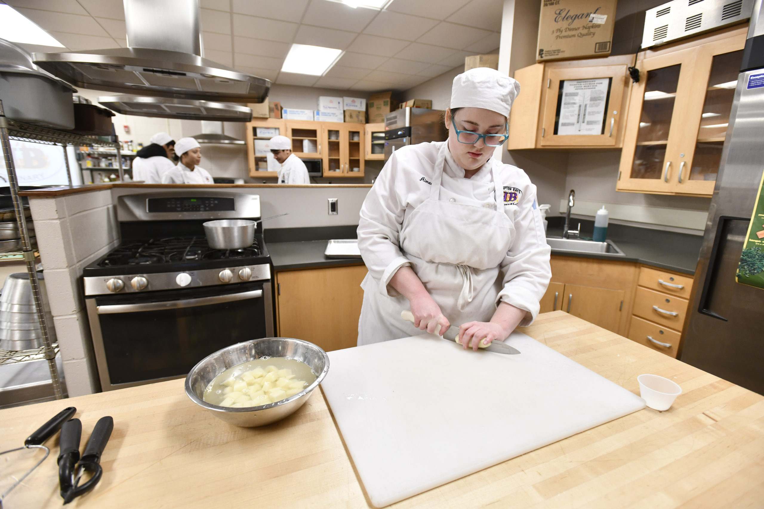 Student Aimee Pelletier works on and assignment during the culinary class at Hampton Bays High School.  DANA SHAW