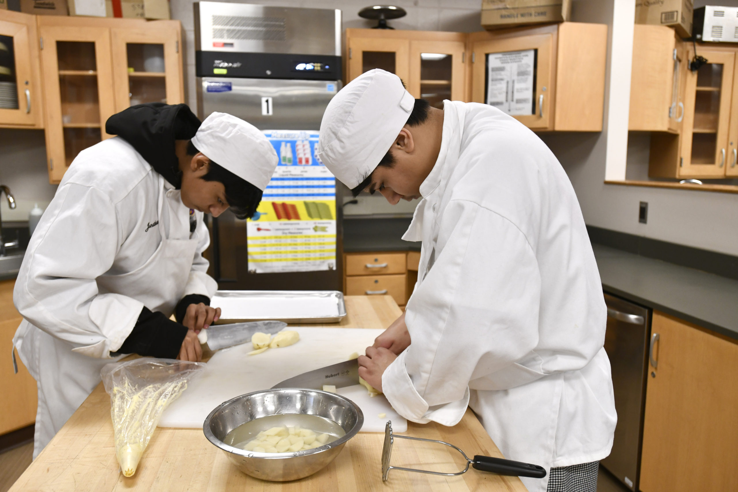 Students Andrew Avila and Jonathan Aquilar at work in the kitchen during the culinary class at Hampton Bays High School.  DANA SHAW