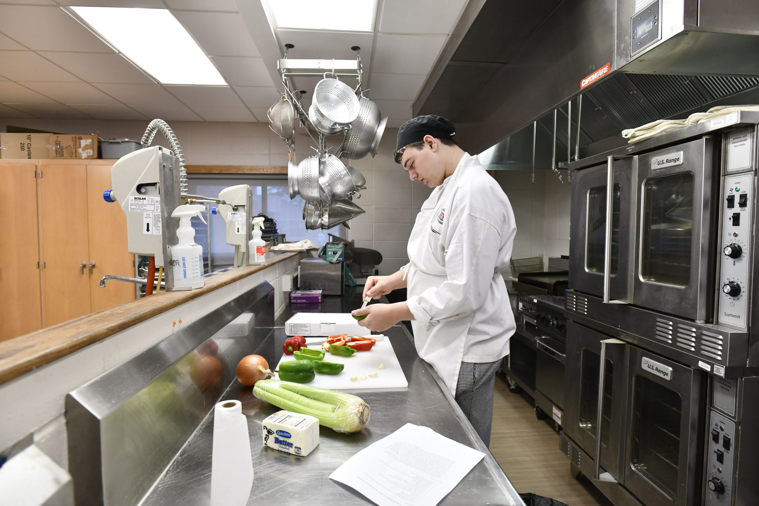 Dylan Carbone at work in the kitchen during the culinary class at Hampton Bays High School.  DANA SHAW