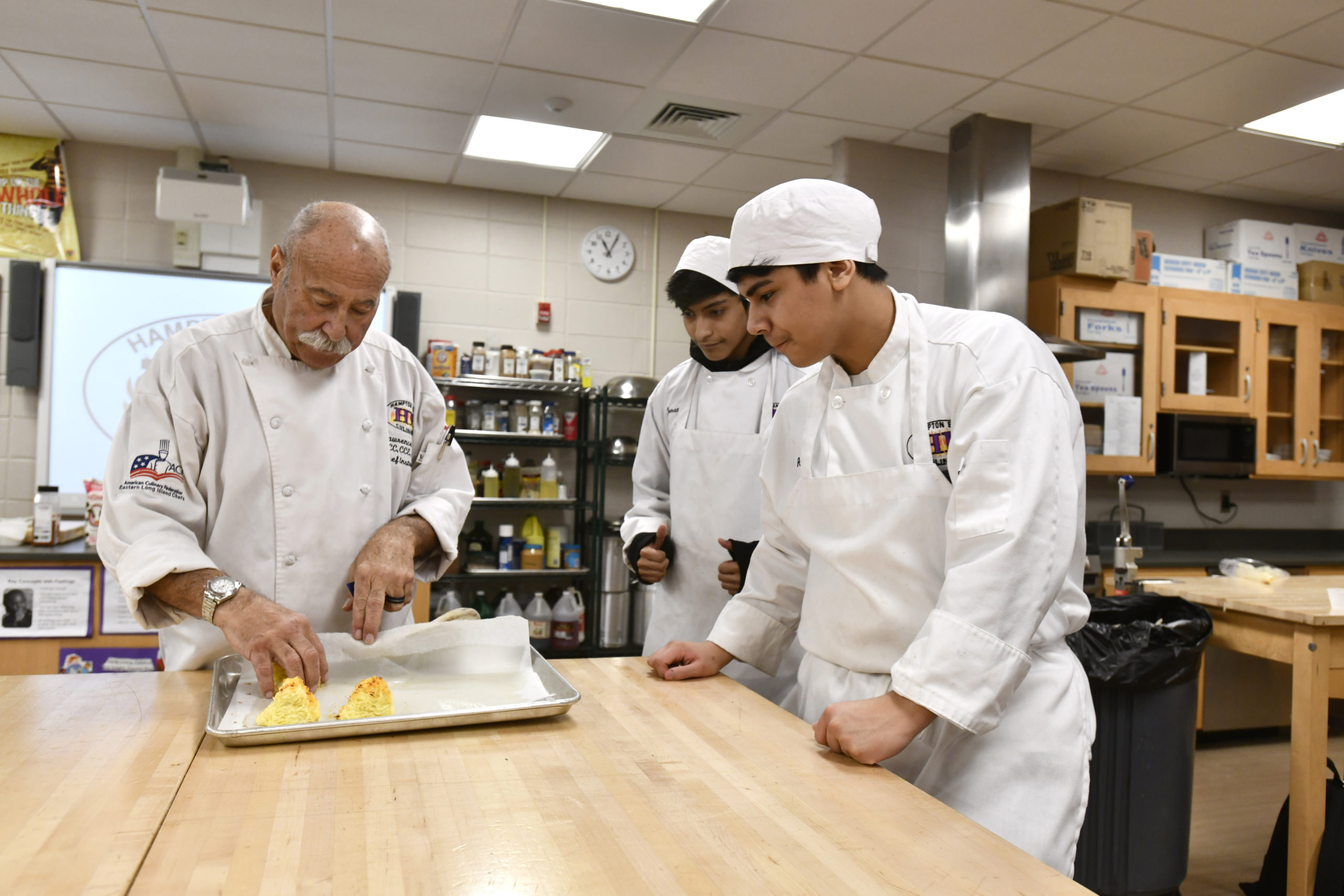 Chef Larry Weiss works with his students during the culinary class at Hampton Bays High School on Thursday, February 6. DANA SHAW