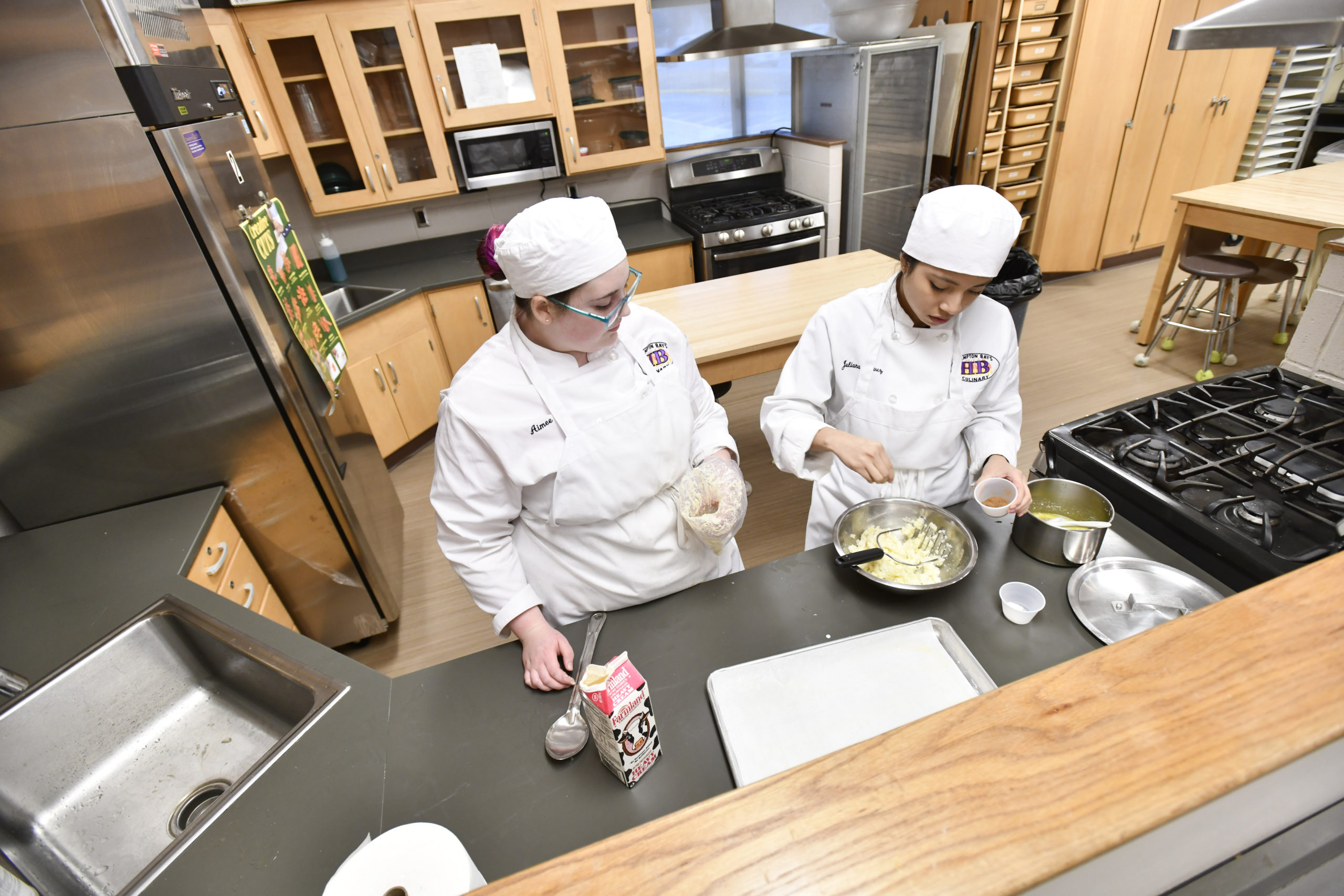 Students Aimee Pelletier and Juliana Alvarez work on and assignment during the culinary class at Hampton Bays High School. DANA SHAW