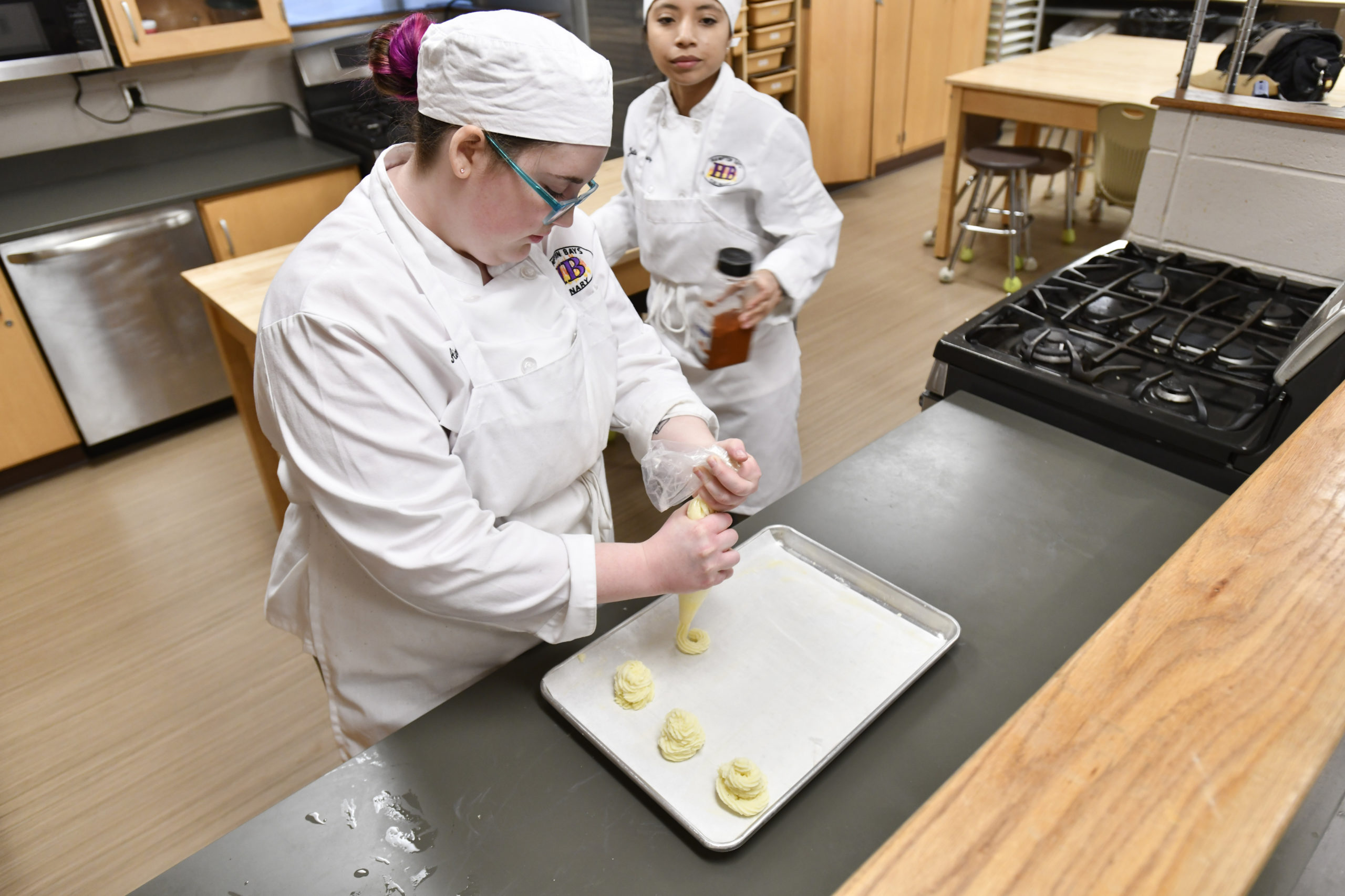 Students Aimee Pelletier and Juliana Alvarez work on and assignment during the culinary class at Hampton Bays High School. DANA SHAW