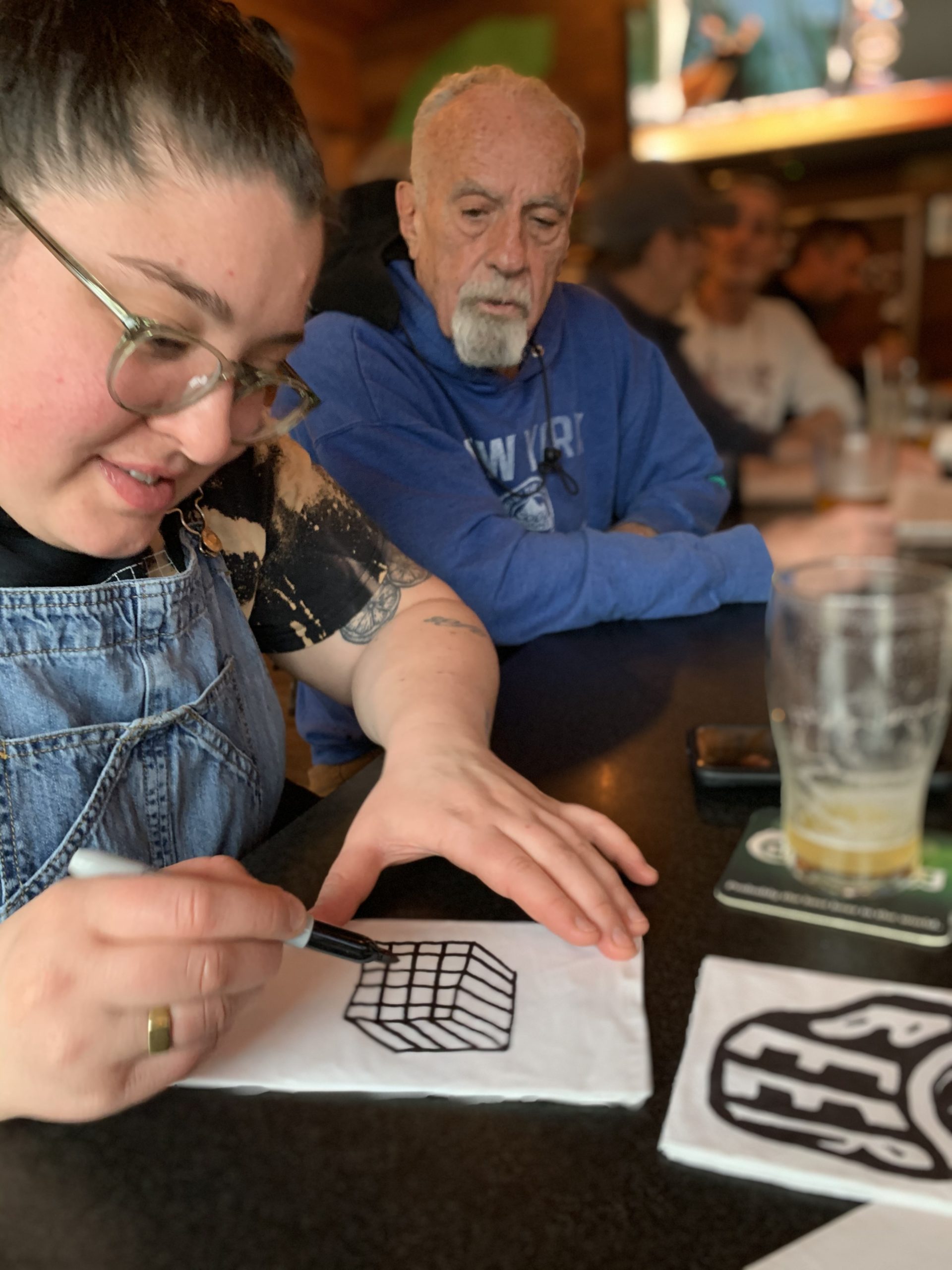 Brianna Ashe drawing on a napkin at Townline BBQ.