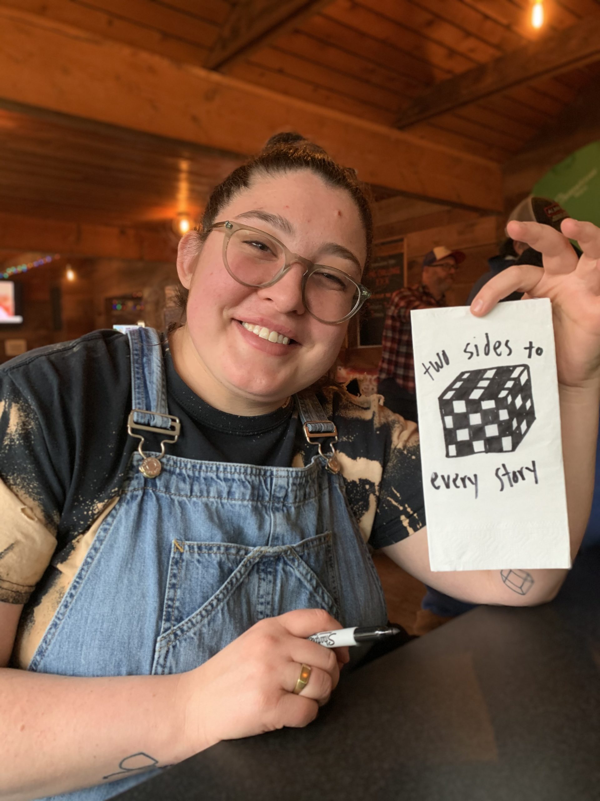 Brianna Ashe drawing on a napkin at Townline BBQ.