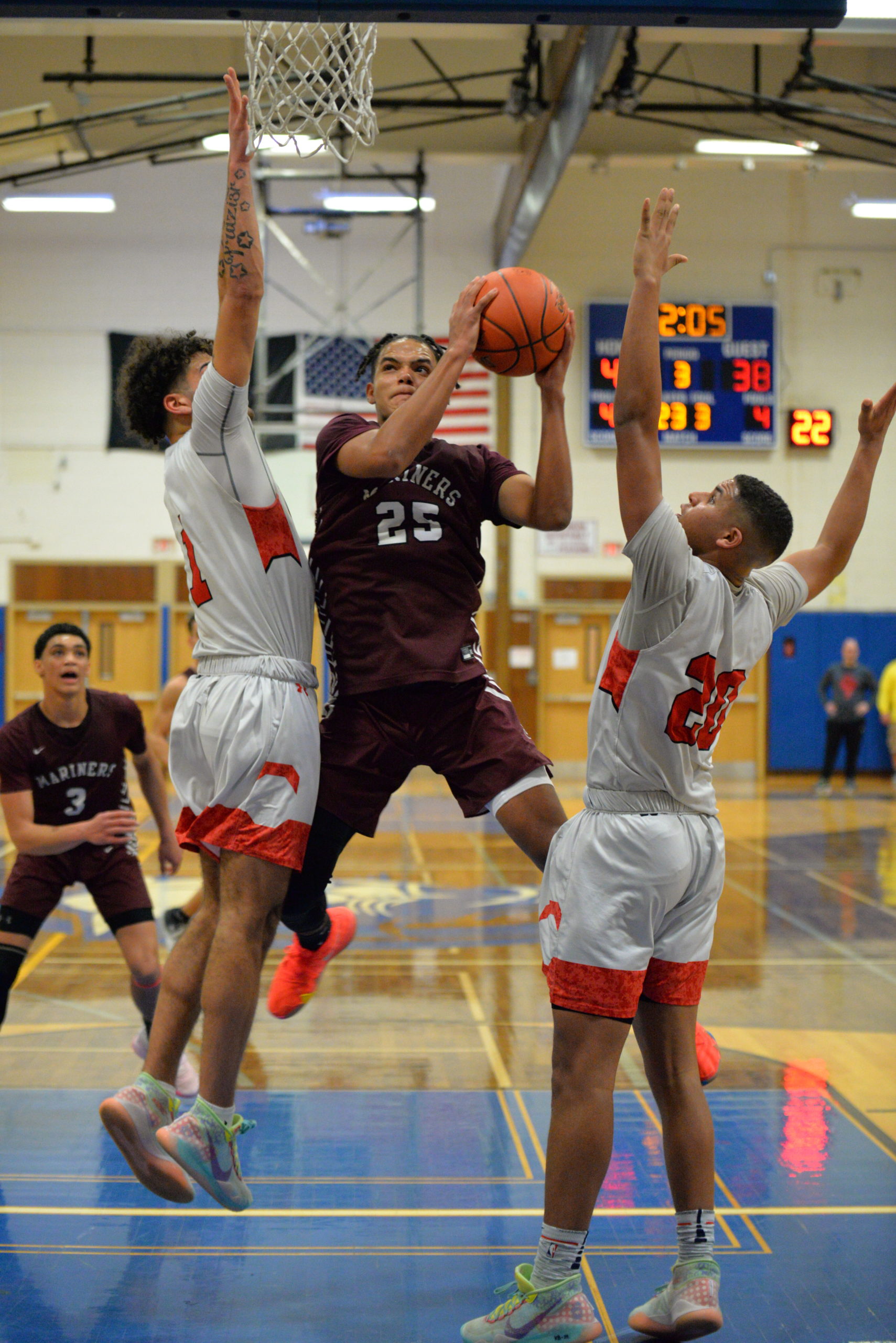 Southampton sophomore LeBron Napier tries to avoid a pair of Center Moriches defenders in the paint.